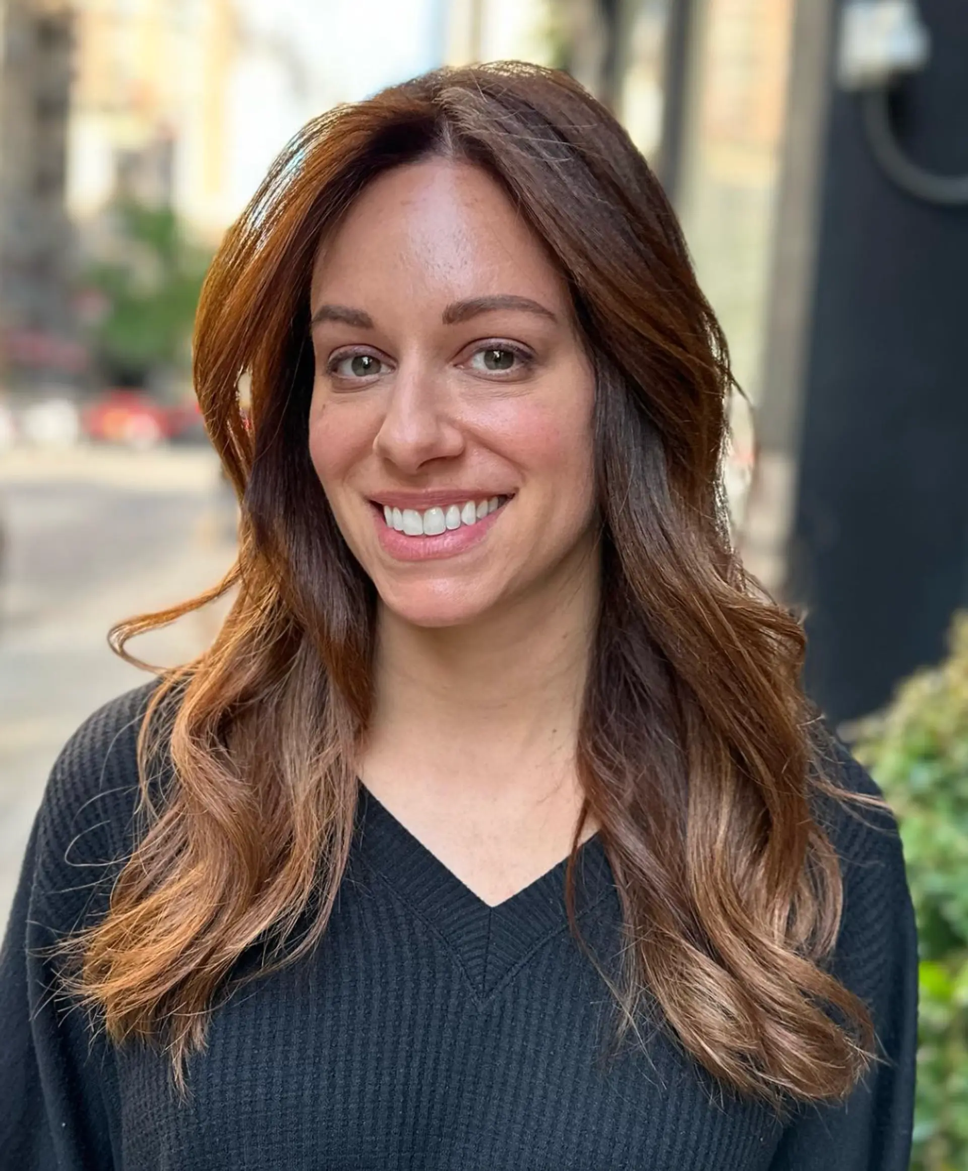 Long, light brown wavy hair with golden highlights, soft waves, face-framing layers, and a side part.

 3