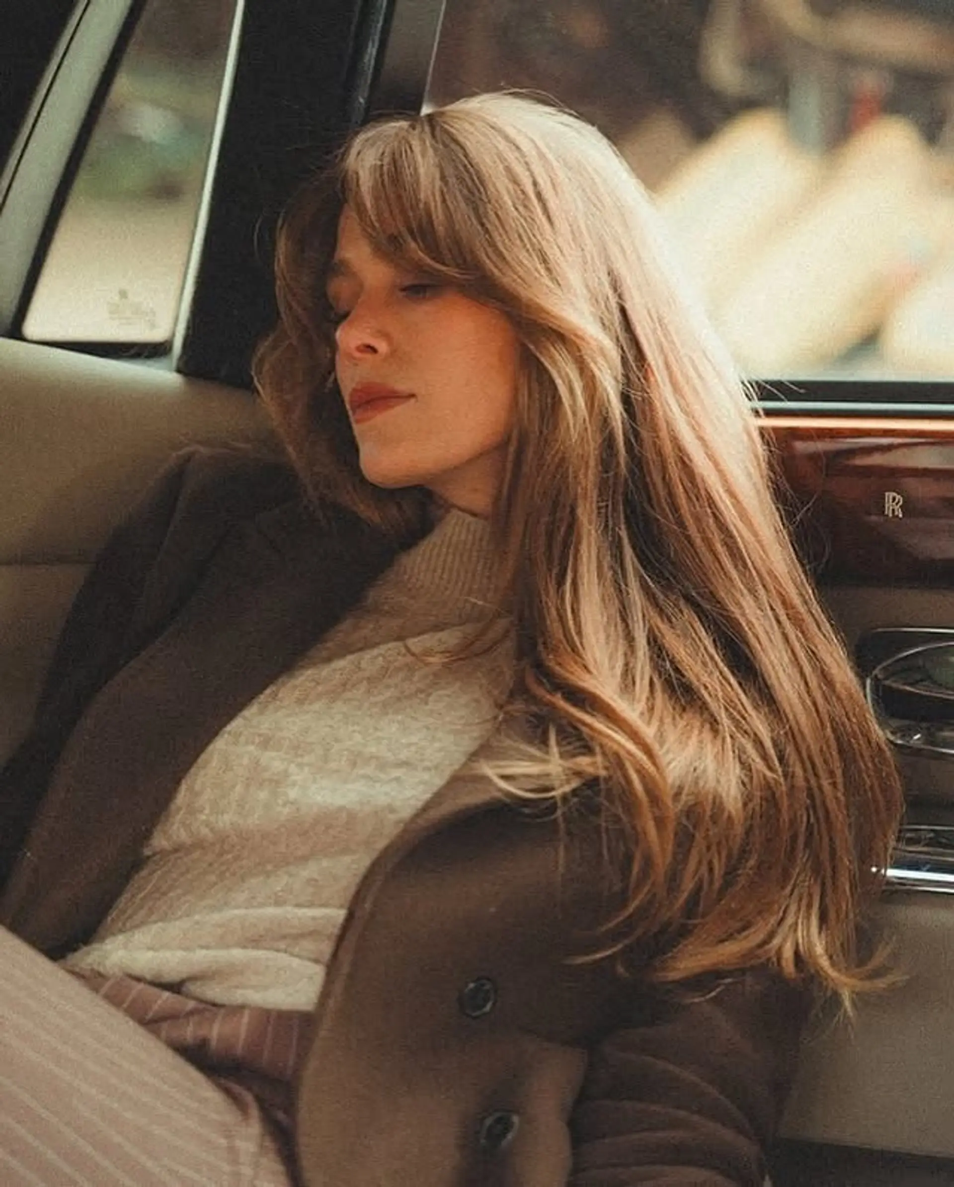 A long, wavy hairstyle with face-framing curtain bangs, styled in a 70s-inspired glam wave. 1