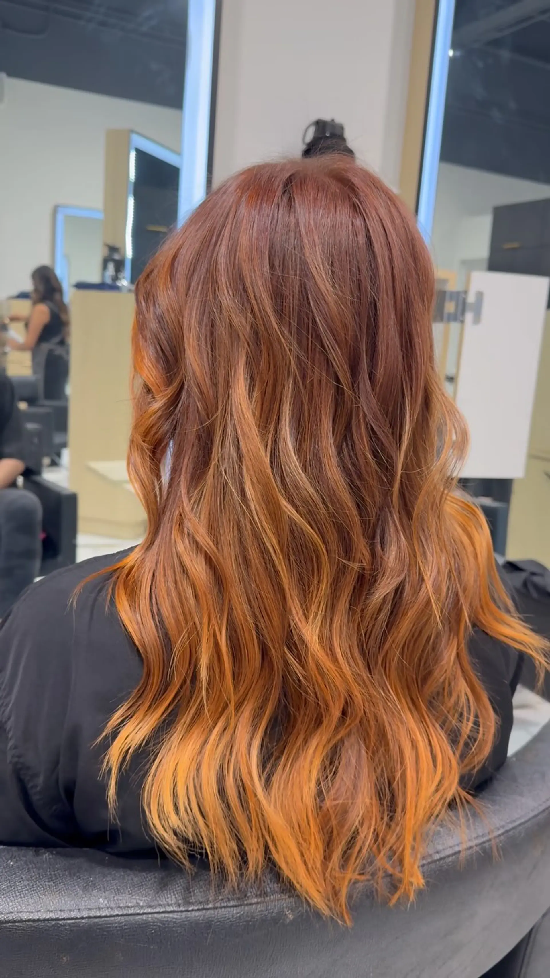 Long layered hair featuring a rich auburn-to-copper gradient styled in soft, flowing waves. 1