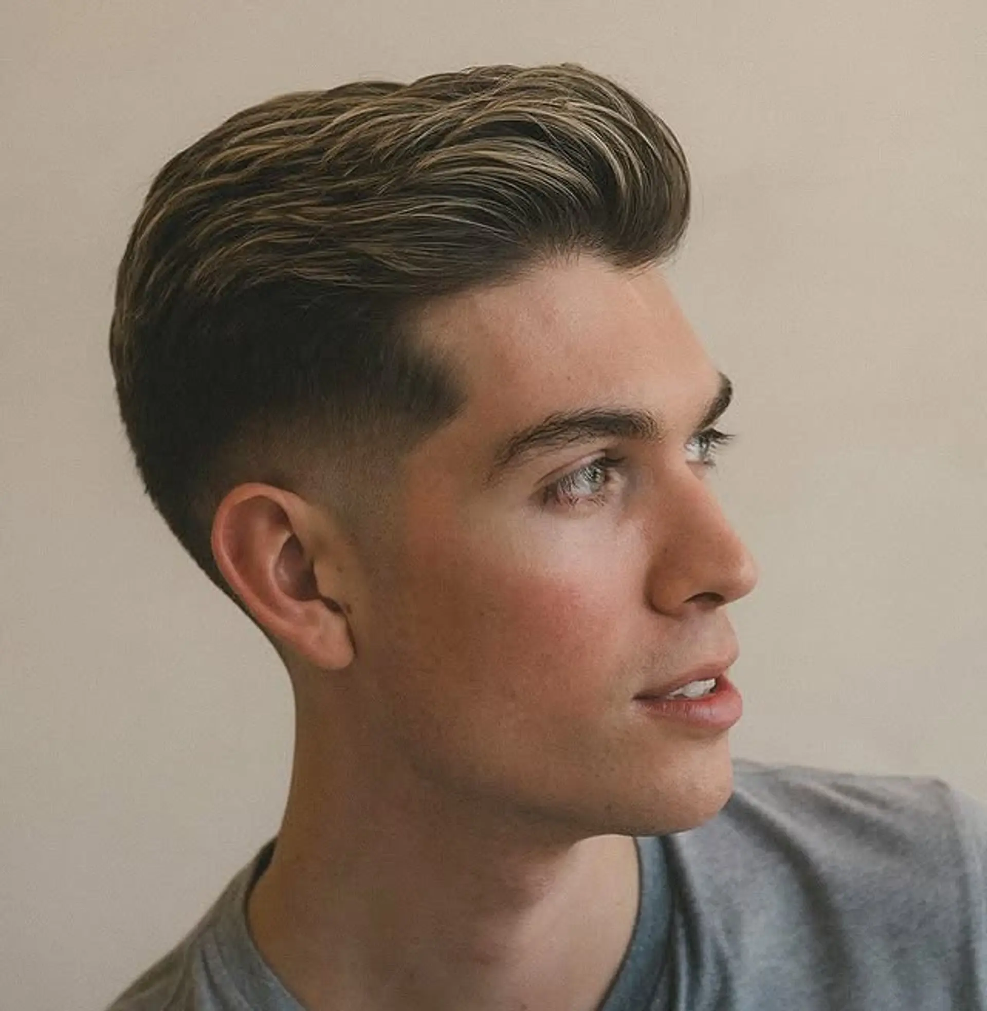 A modern, low fade with a textured top and subtle highlights. 1