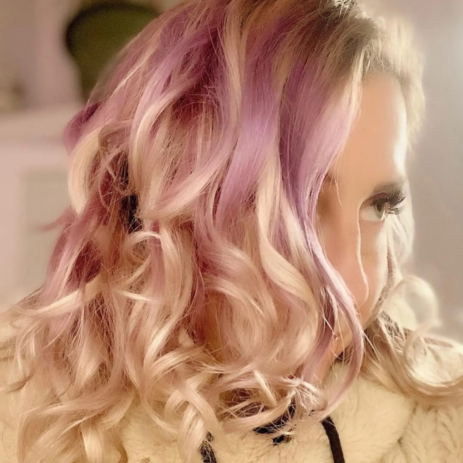 Medium-length blonde hair styled in loose curls with soft lilac and lavender highlights. 1