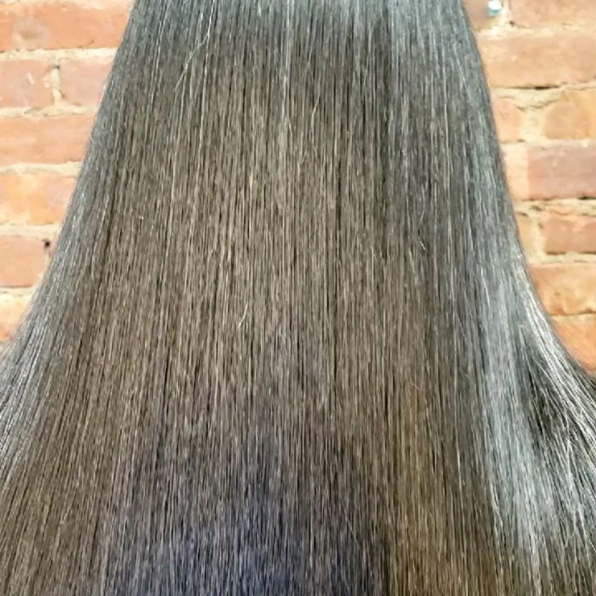 Close-up of sleek, ultra-straight dark hair showing exceptional smoothness and glossy texture. 1