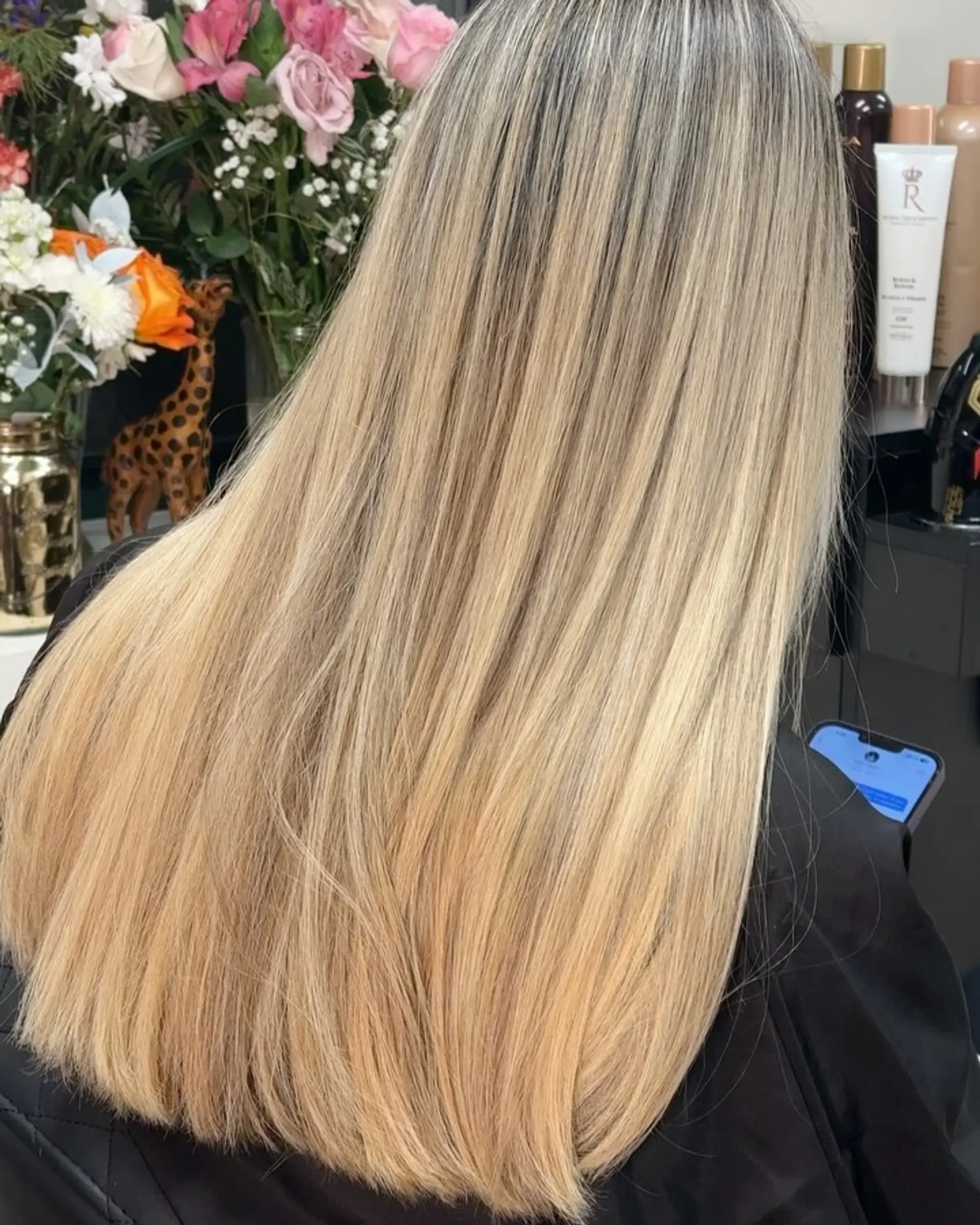 Long, sleek straight hair featuring finely blended warm blonde highlights with a soft root shadow. 1