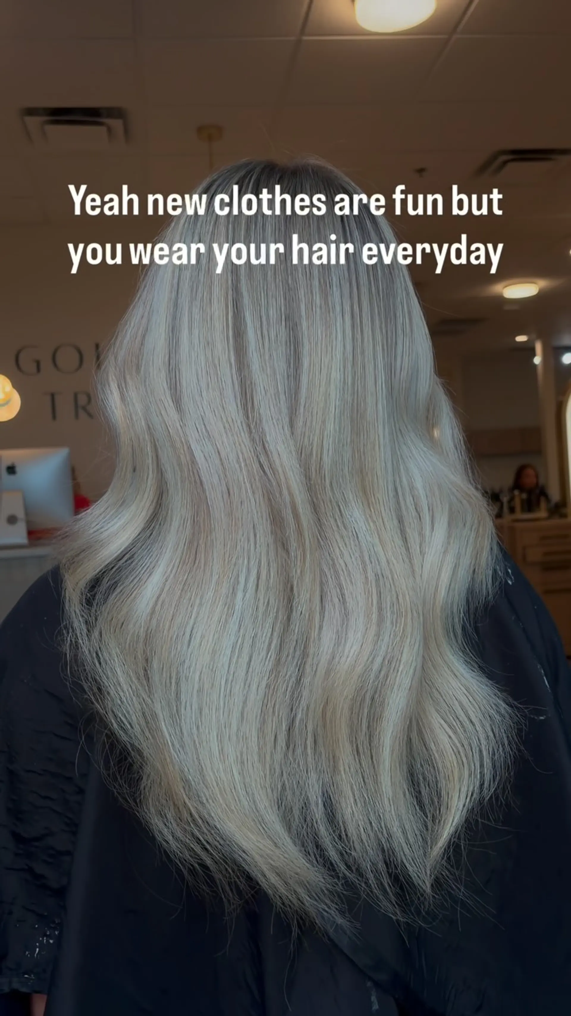 Long, bright platinum blonde hair styled with seamless cool tones and soft body waves cascading down the back. 1