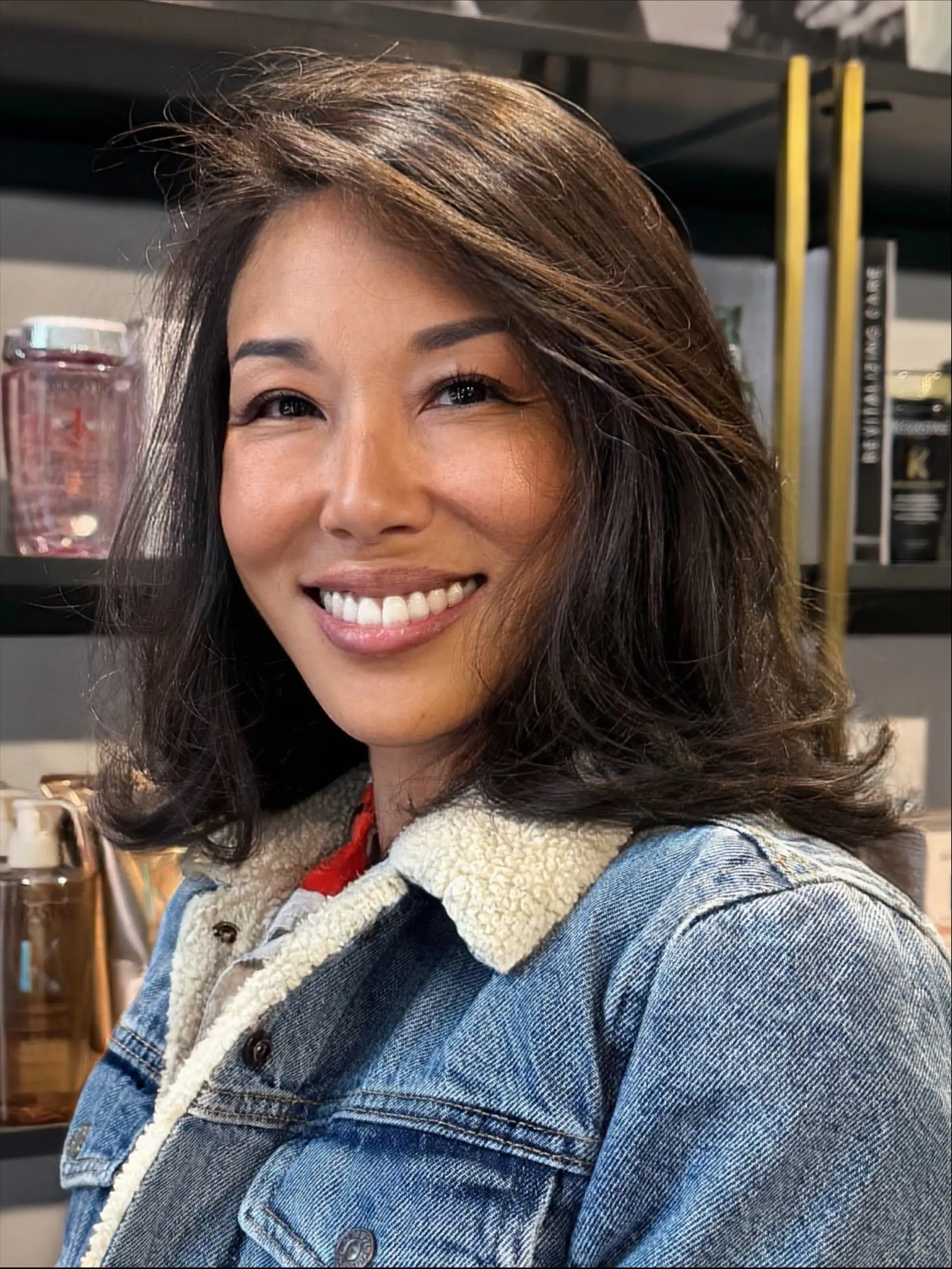 A collarbone-length layered haircut styled with soft, flipped-out ends and natural volume. 1