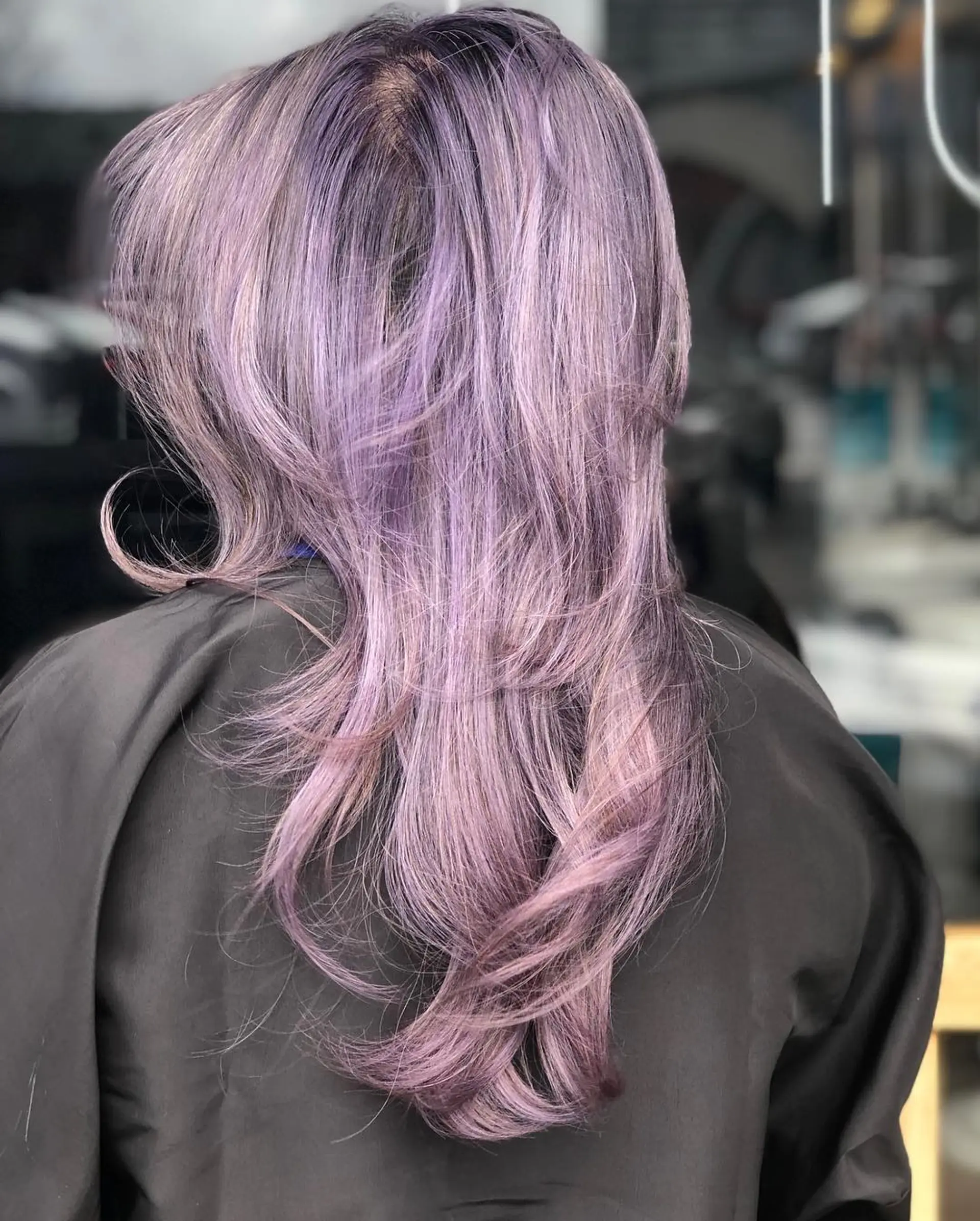 Long layered cut featuring soft, flipped-out ends in a dreamy pastel lilac and silver-violet tone. 1