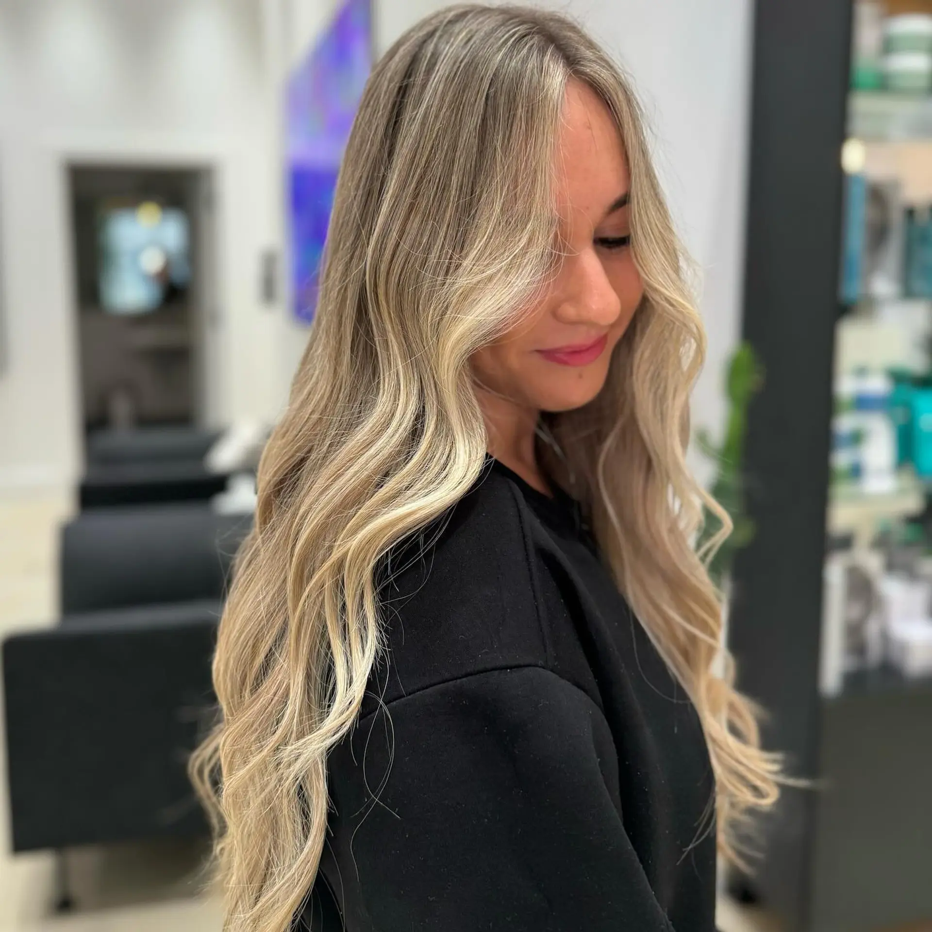 Long, wavy hairstyle with a blonde balayage and face-framing layers. 1