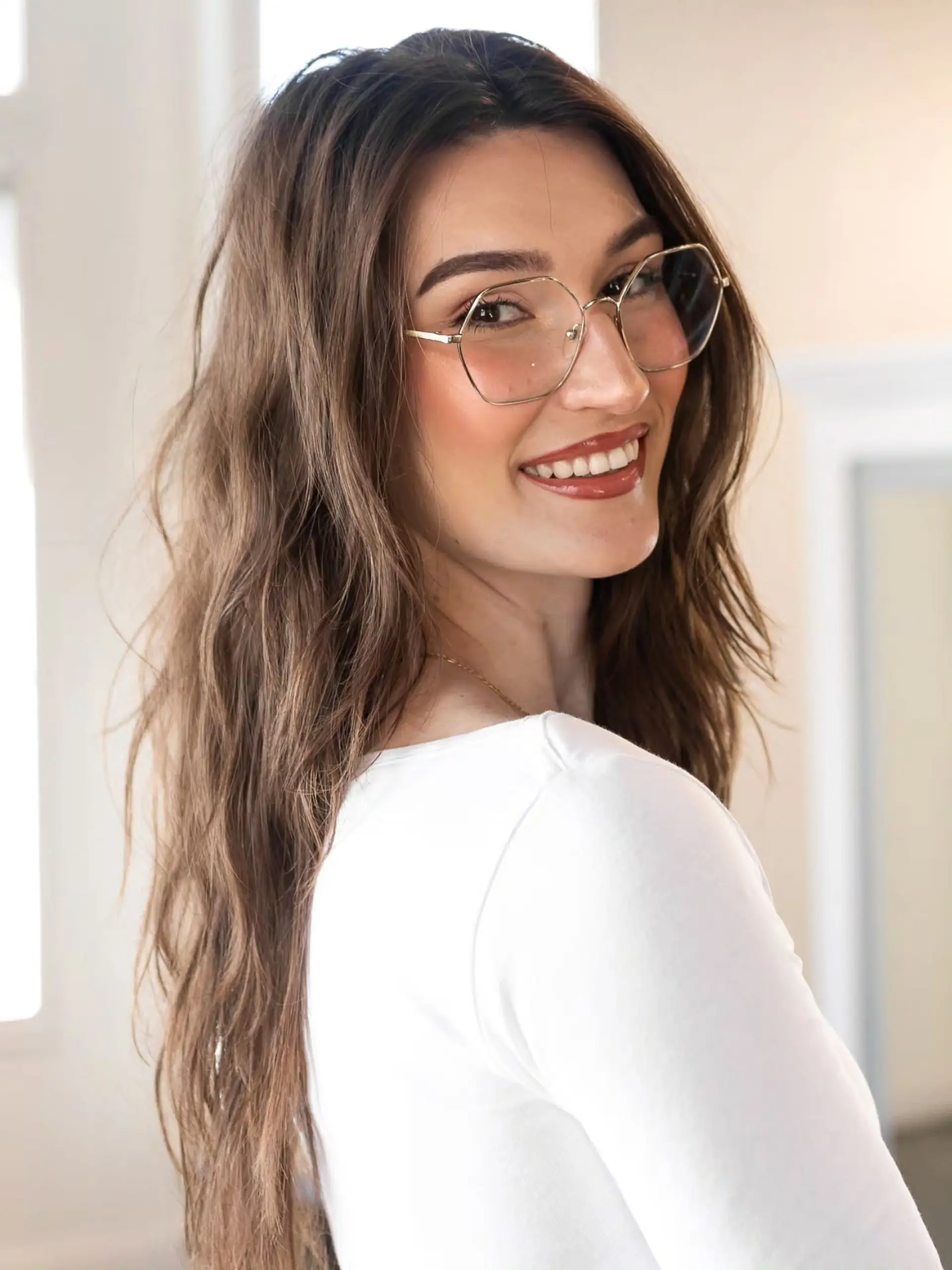 Long dimensional brunette hair styled in loose, textured waves with soft layers. 1