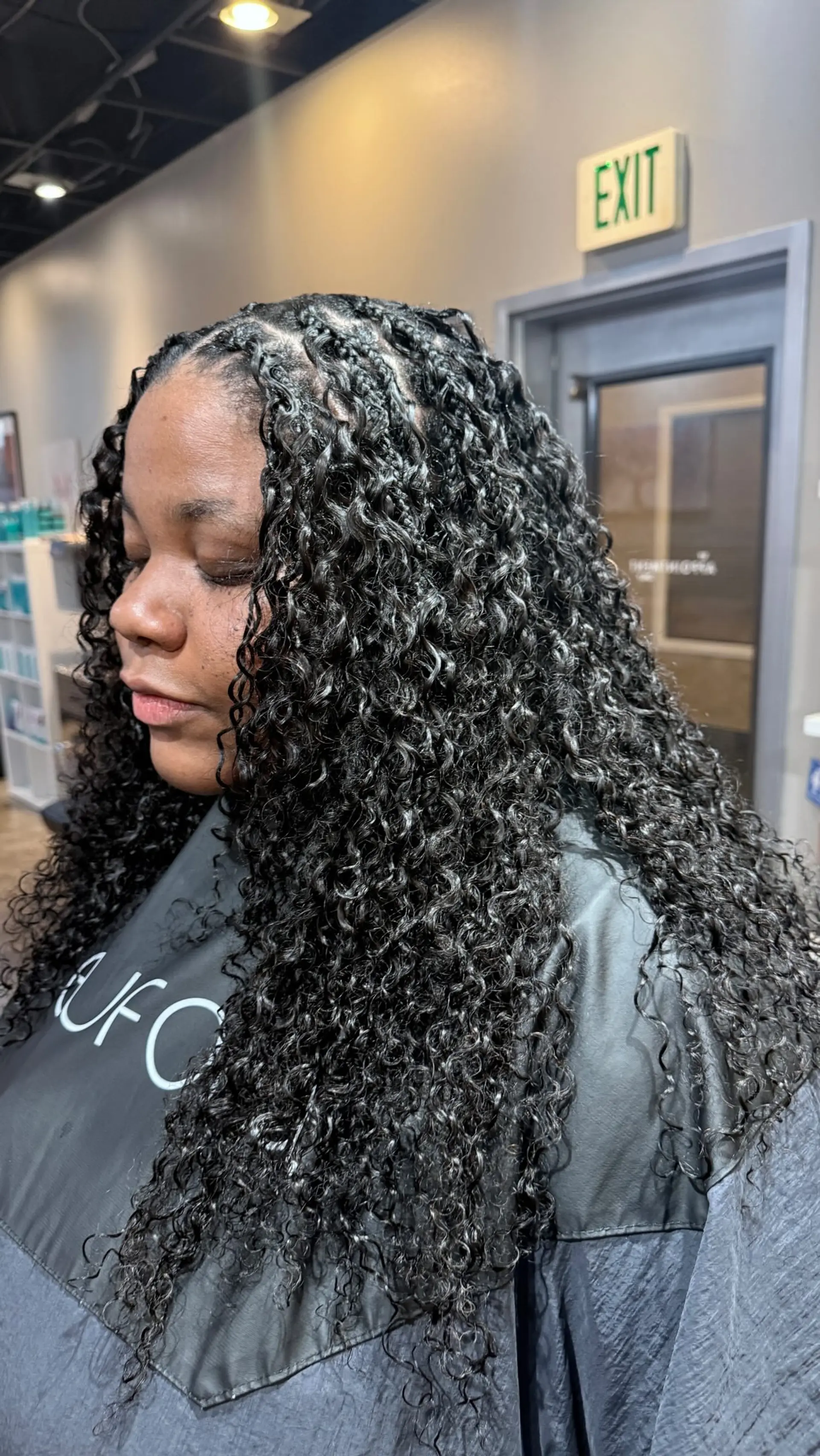 Long, defined spiral curls starting from small, precise root knots and braids. 1