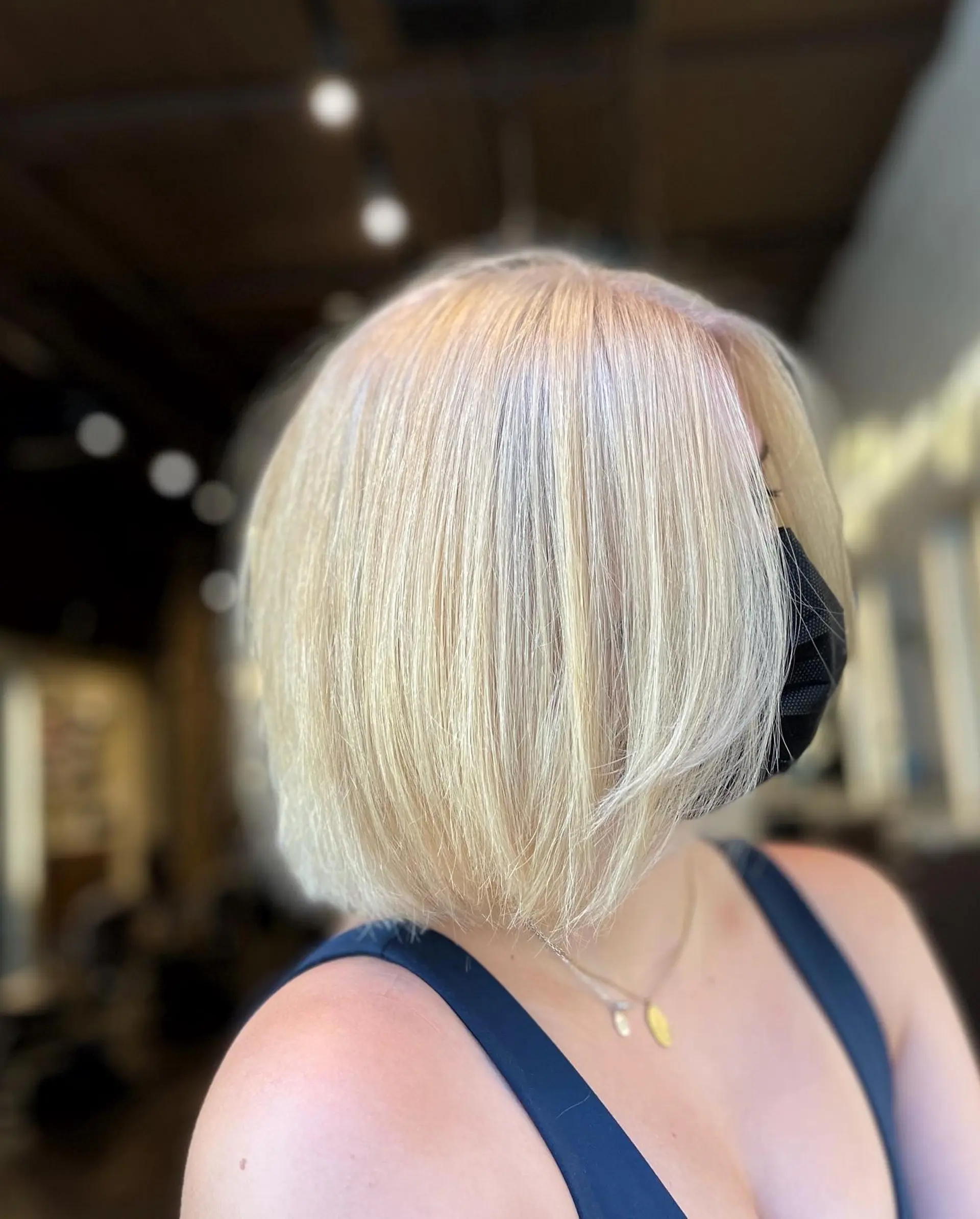 A chic, icy blonde layered bob cut to chin length. 1