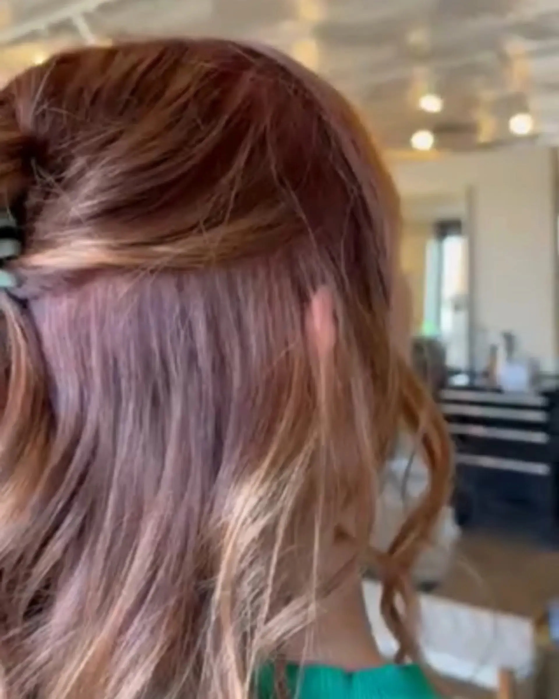 A rich, dimensional warm auburn and copper color styled in soft waves. 1