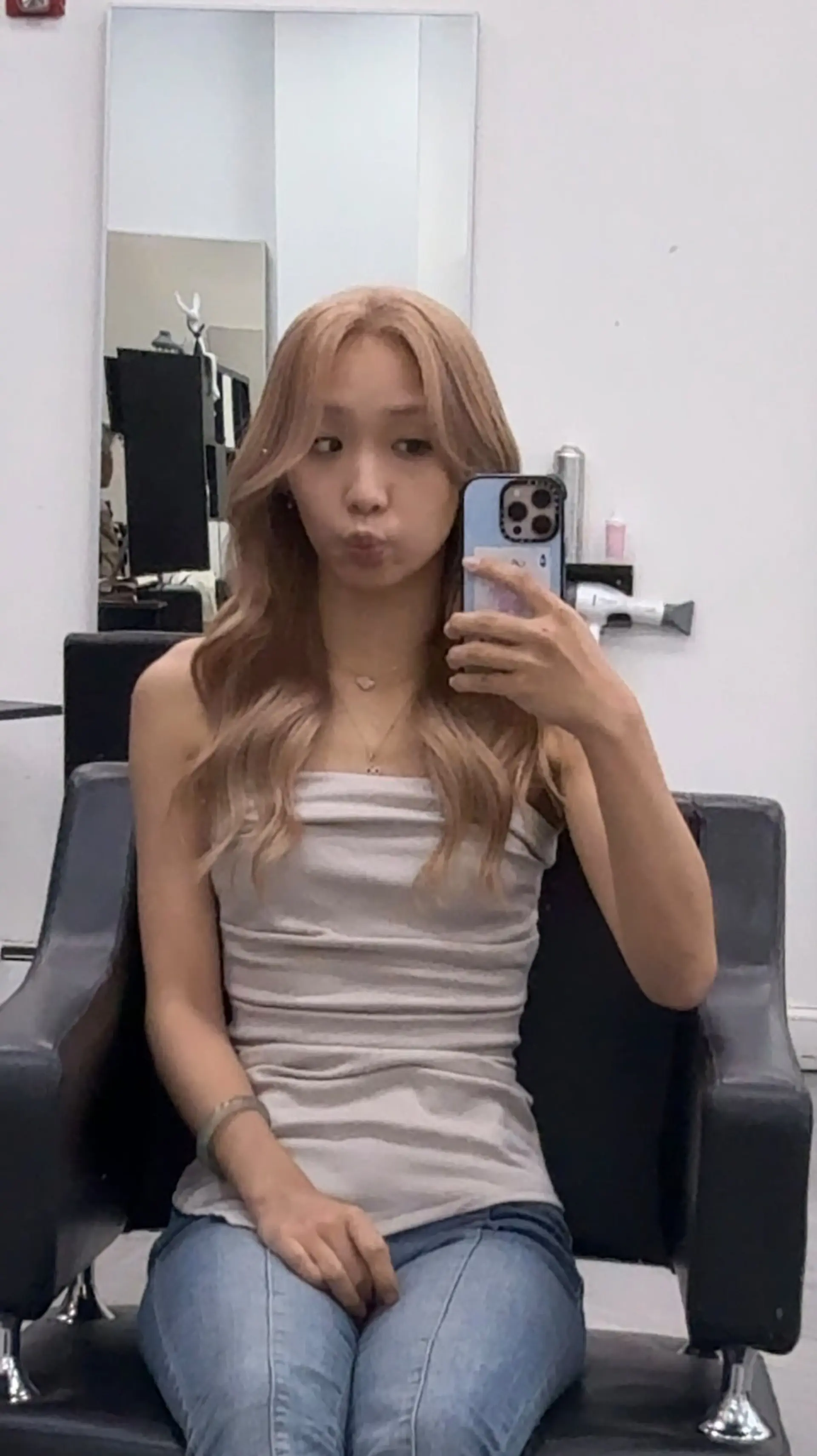 Long beige blonde hair styled into soft, elegant waves with a center part. 1