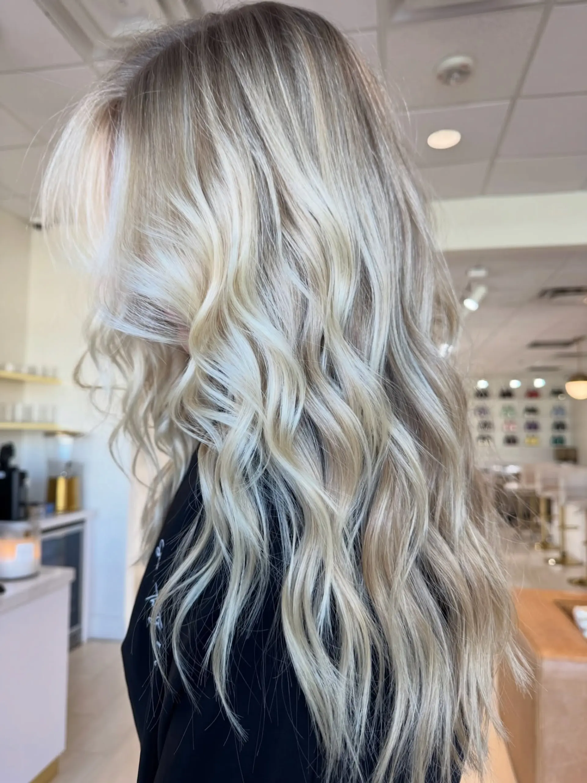 Long, bright icy blonde hair styled with soft, cascading beach waves. 1
