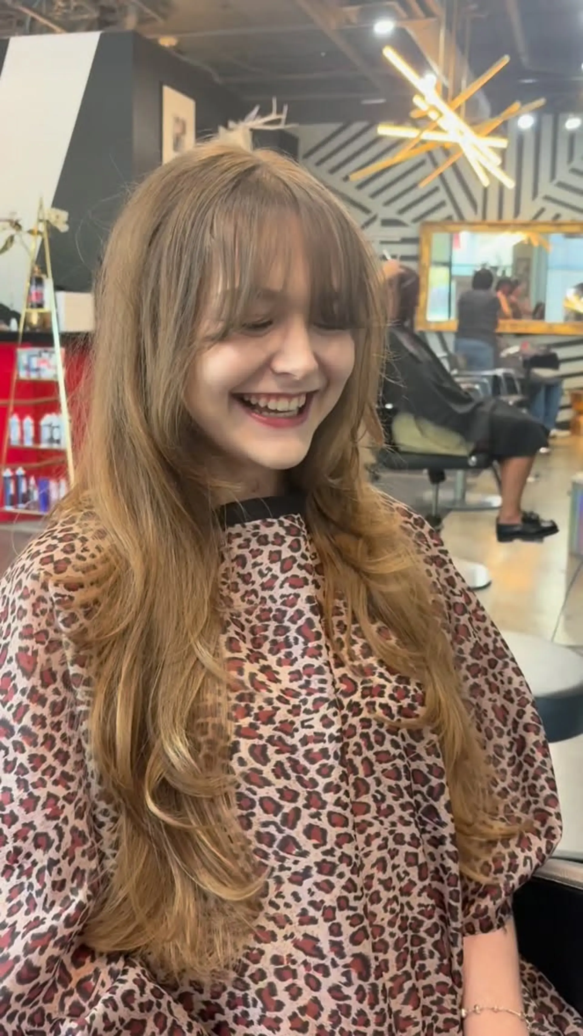 Long heavily layered haircut featuring soft, face-framing fringe bangs and flipped ends. 1
