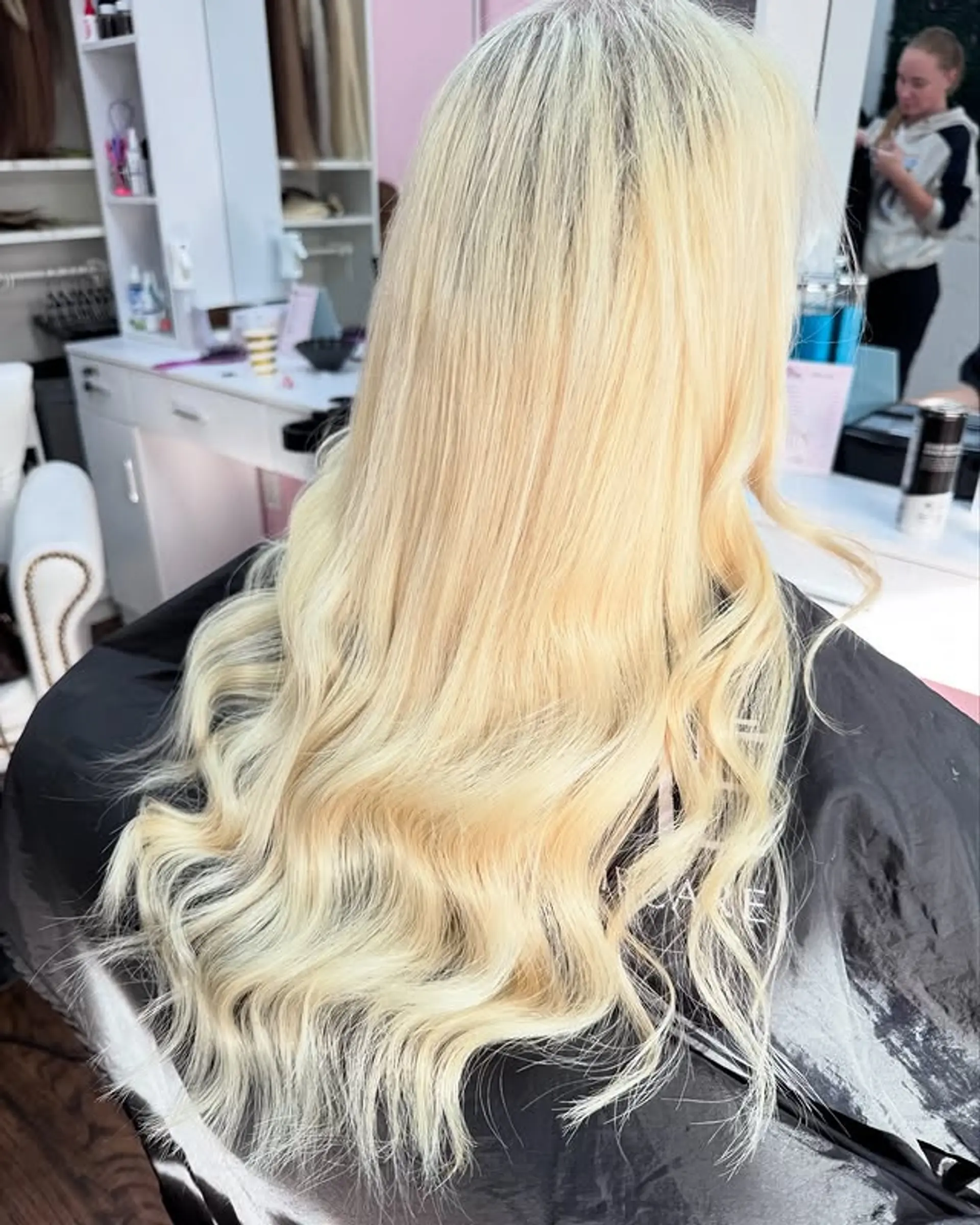 Long platinum blonde hair styled with soft waves. 1