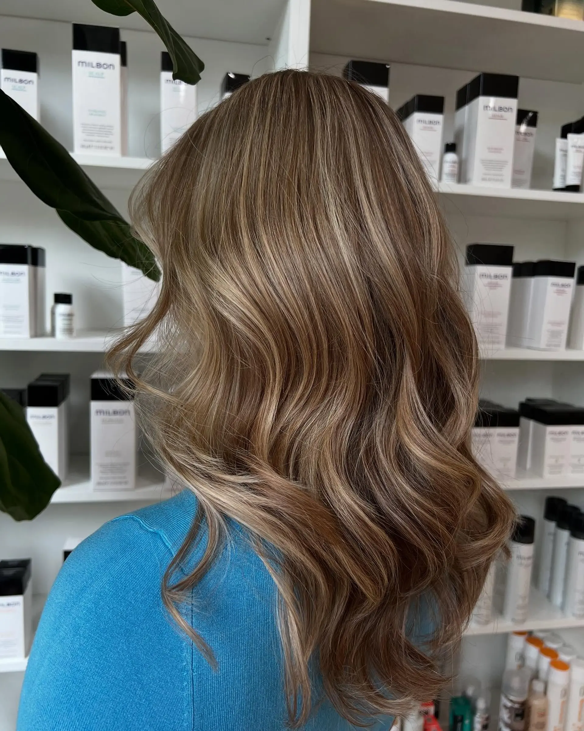 Long wavy hair with seamless dimensional blonde highlights woven through a natural light brown base. 1