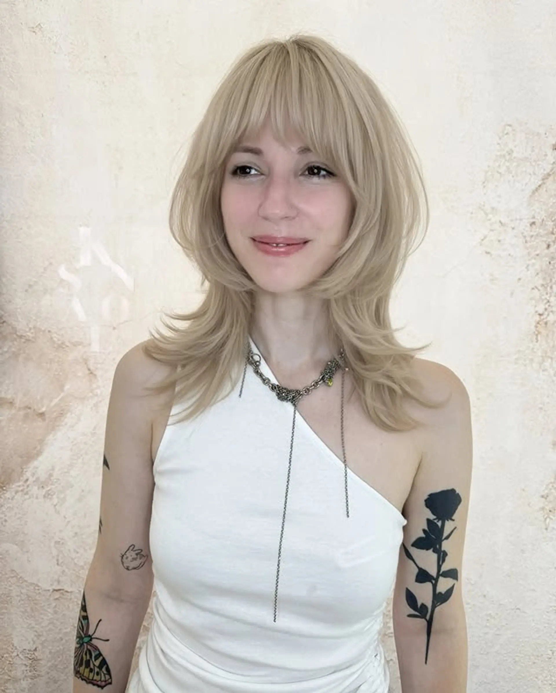 A modern shag haircut with choppy layers and baby bangs. 1