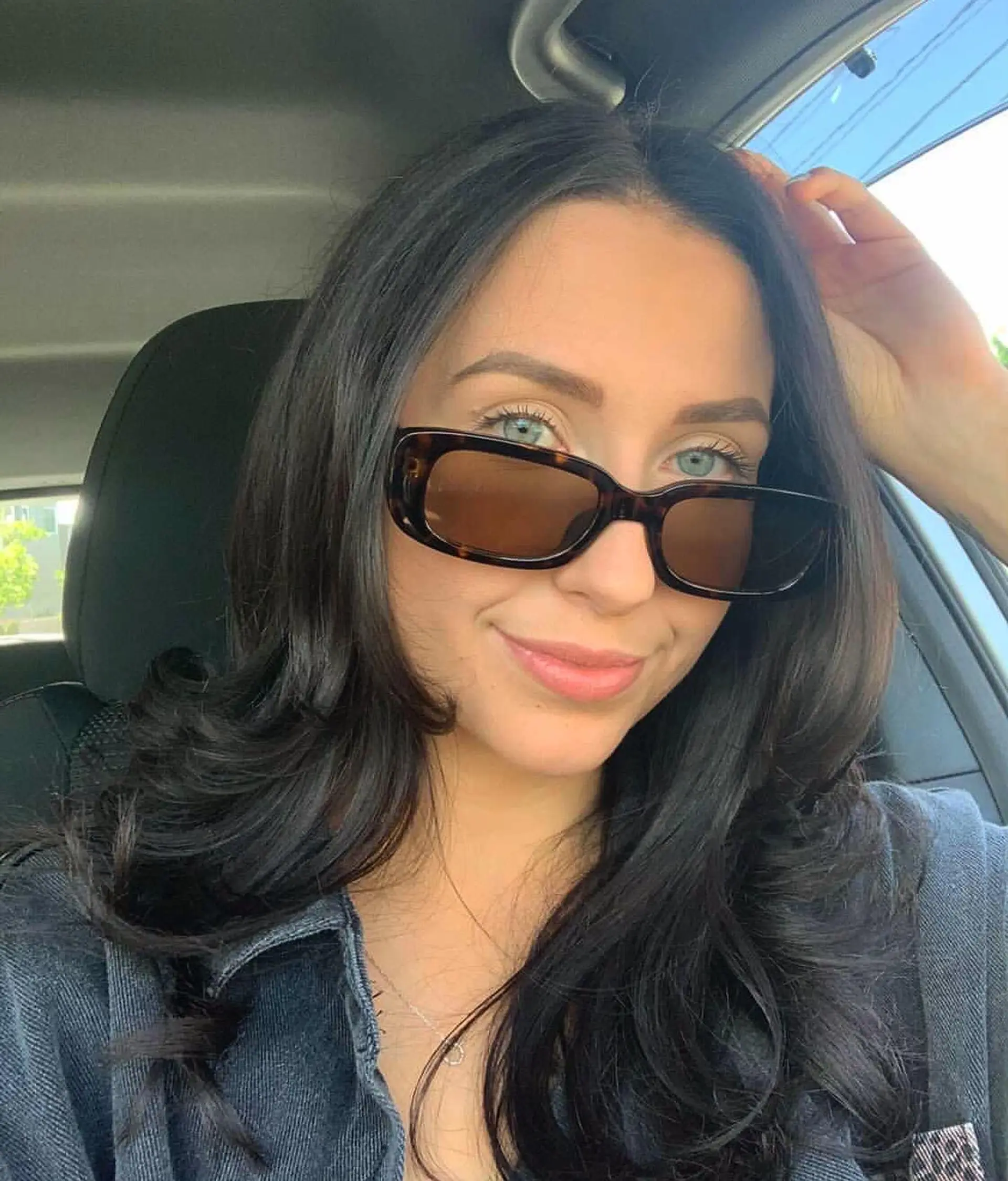 Medium-length dark brunette hair cut with soft framing layers and styled in a polished, voluminous blowout with flipped ends. 1