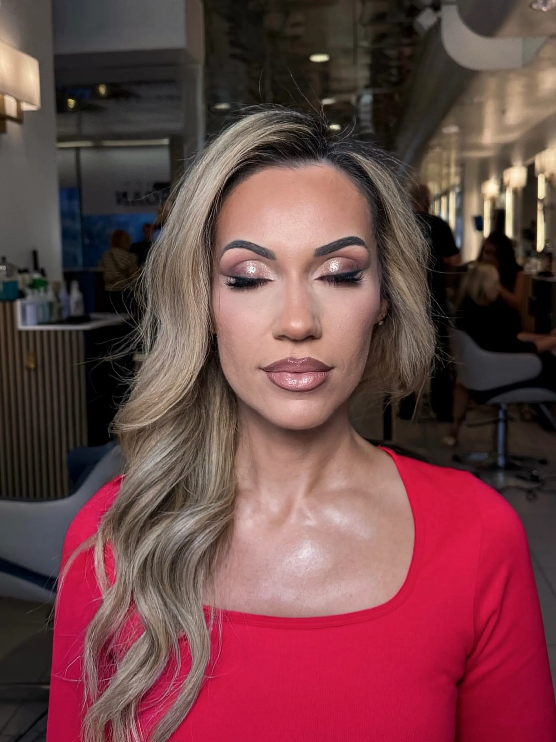 A glamorous side-swept style featuring soft, voluminous waves and blended ash blonde highlights. 1