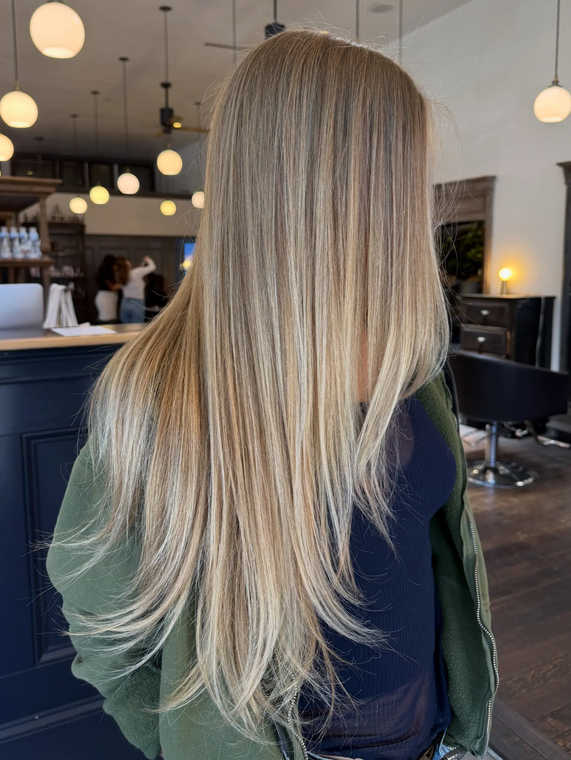 Long, sleek straight hair featuring a blend of fine highlights and balayage in a creamy blonde tone. 1