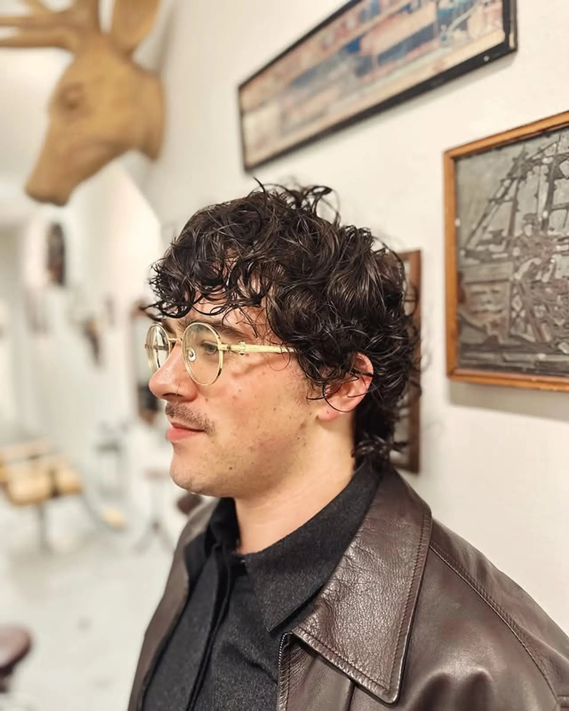 A modern take on the classic mullet featuring natural curls and a layered cut. 1