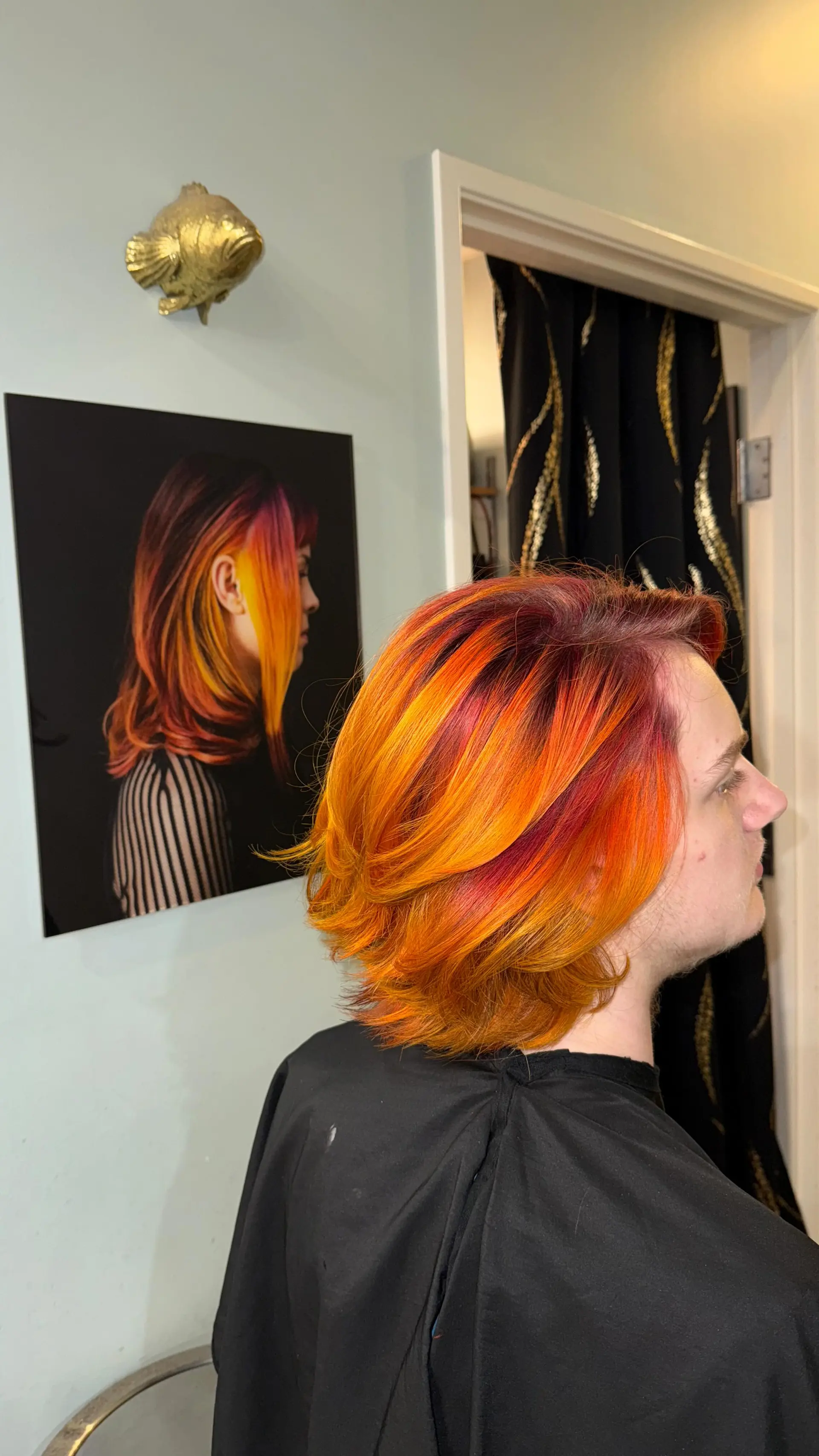 A vibrant fire-toned layered hairstyle featuring dimensional shades of deep red, electric orange, and yellow. 1