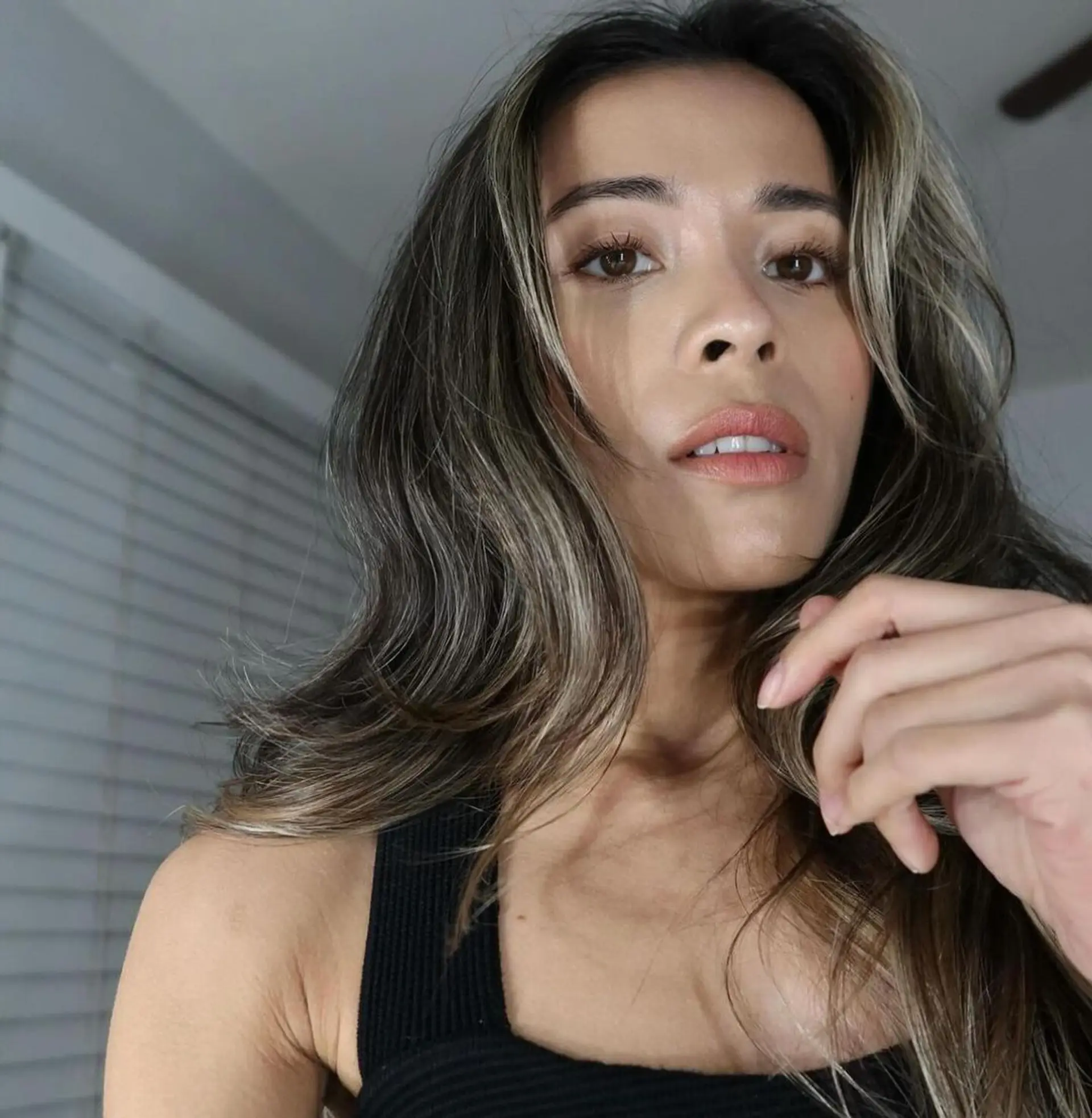 A long, wavy hairstyle with dark brown base color and ash blonde highlights, featuring a natural wave pattern and face-framing layers. 1