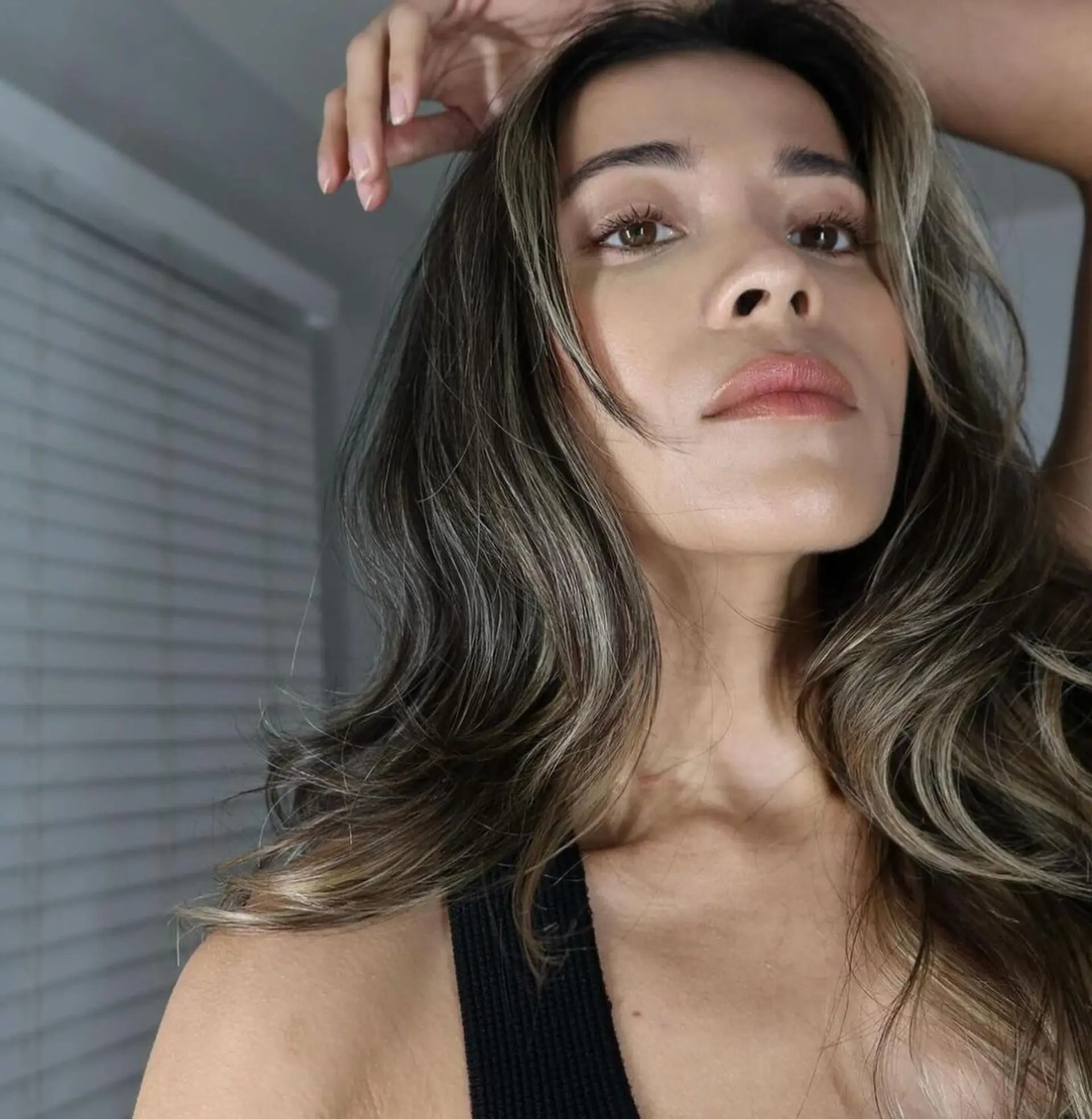 A long, wavy hairstyle with dark brown base color and ash blonde highlights, featuring a natural wave pattern and face-framing layers. 2