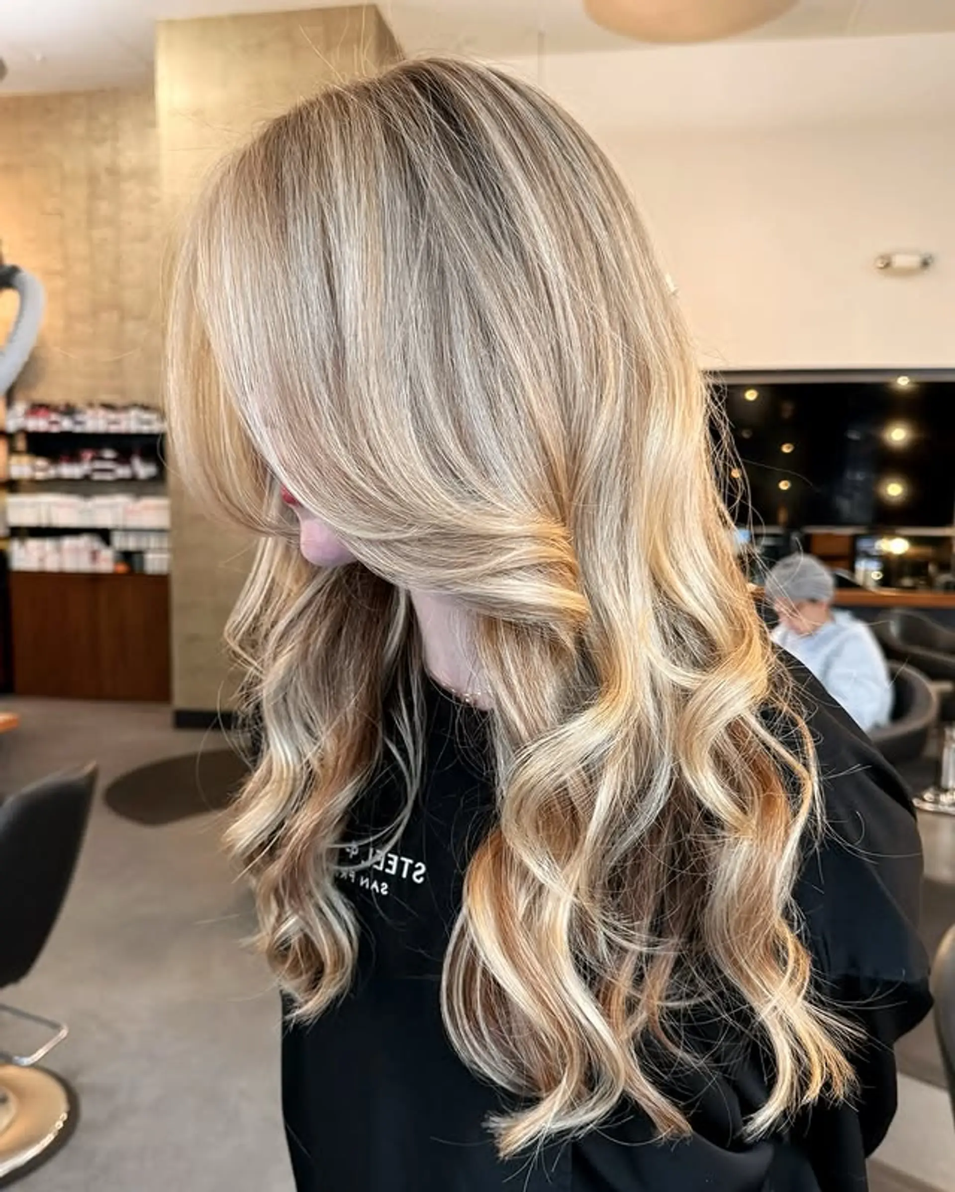 Long, wavy hair with curtain bangs and face-framing layers. 1