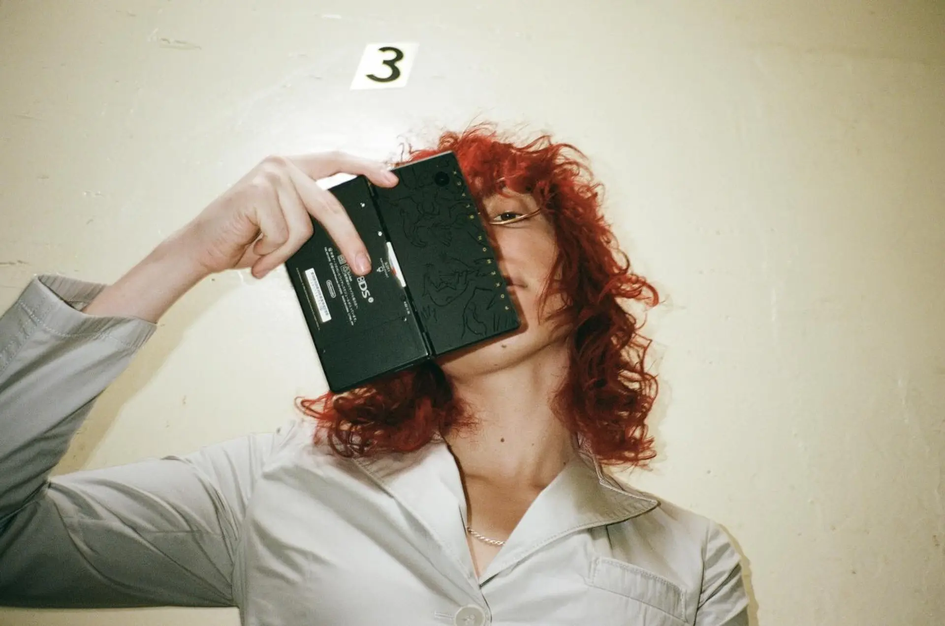 A vibrant copper-red curly shag featuring textured layers and soft, natural volume. 1
