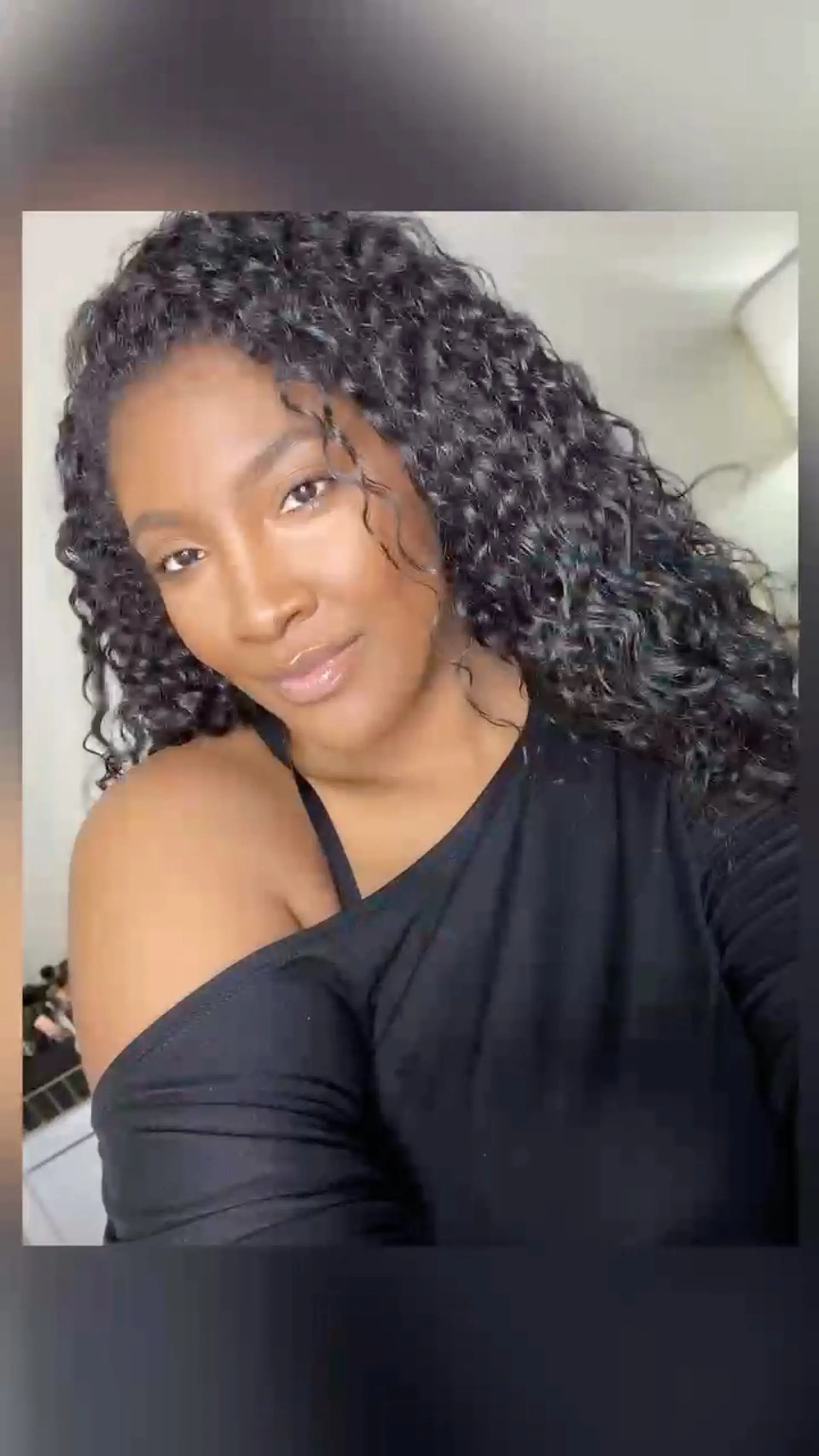 Deeply moisturized, long curly hair with defined, bouncy coils framing the face and falling past the shoulders. 1