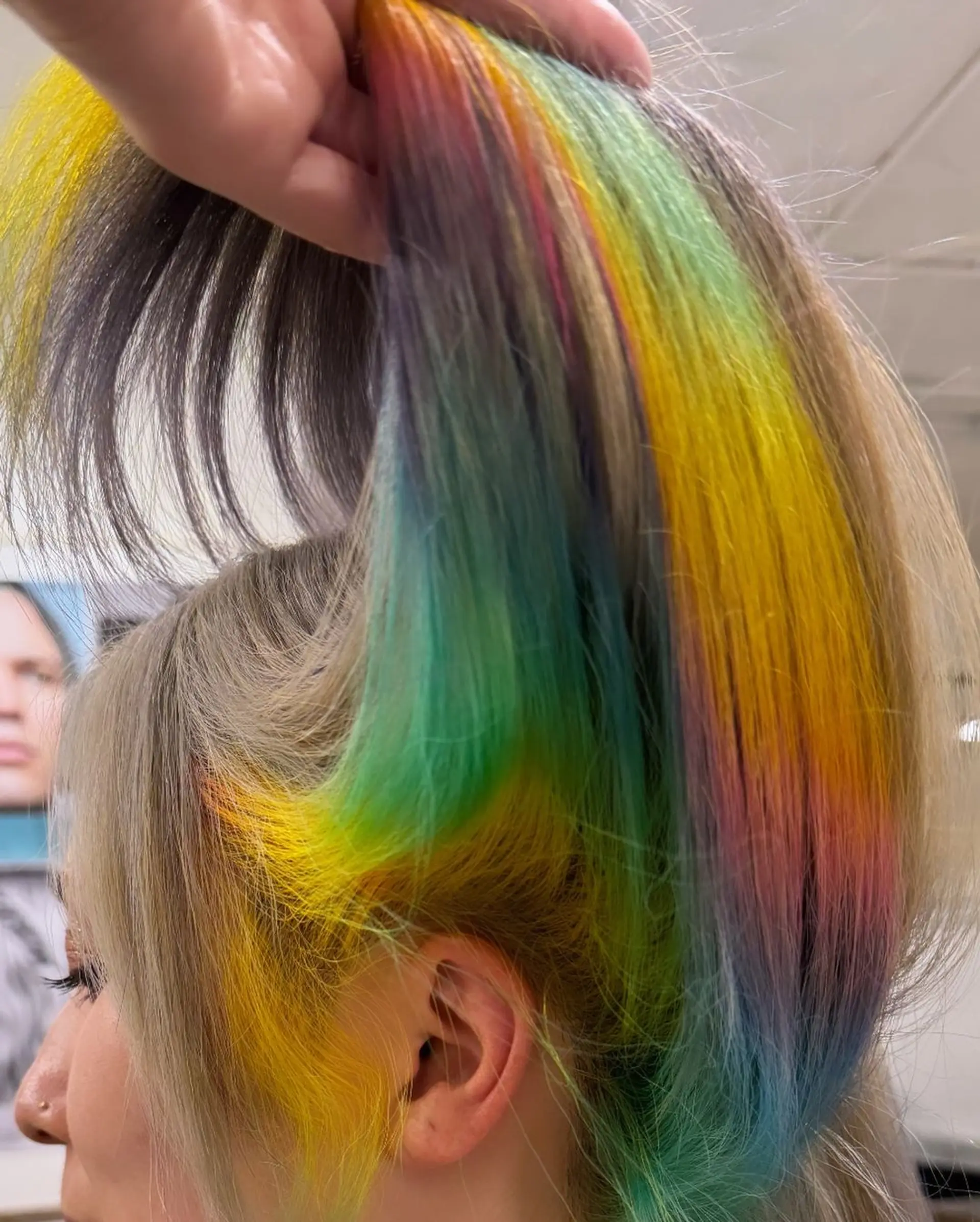A long, straight hairstyle featuring a vibrant, multicolored gradient with bold highlights in yellow, green, blue, purple, orange, and red. 1