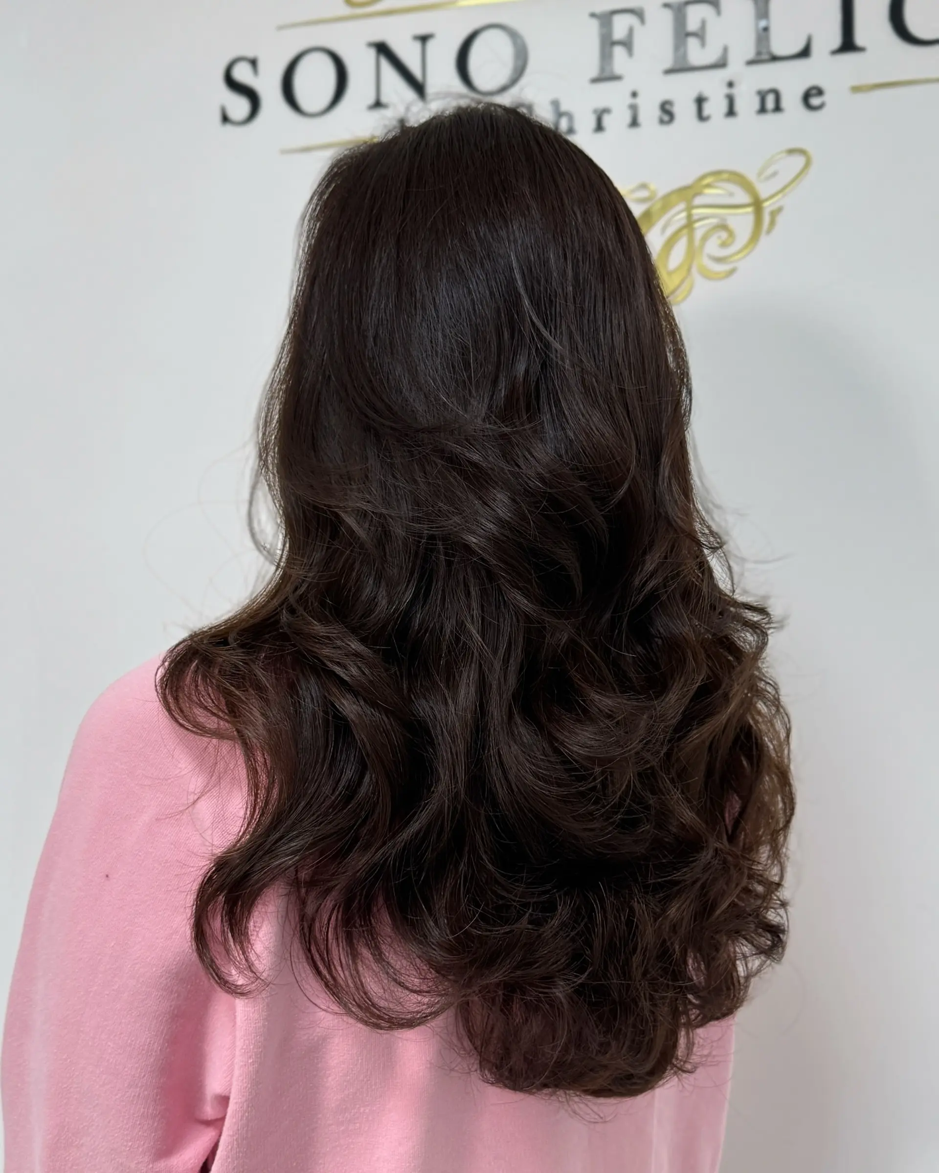 A long, layered hairstyle with soft waves. 1