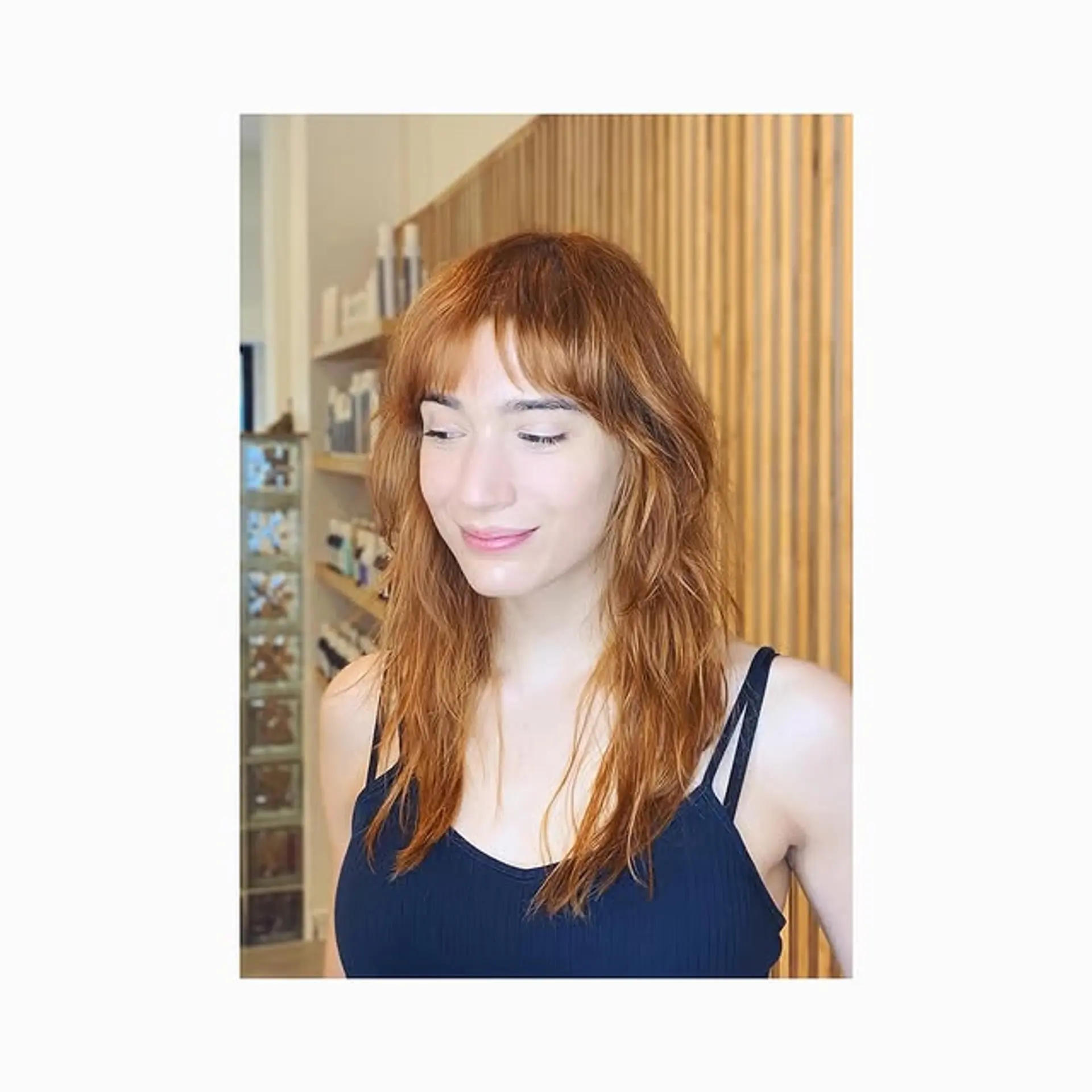 A modern shag haircut with textured layers and wispy bangs. 1