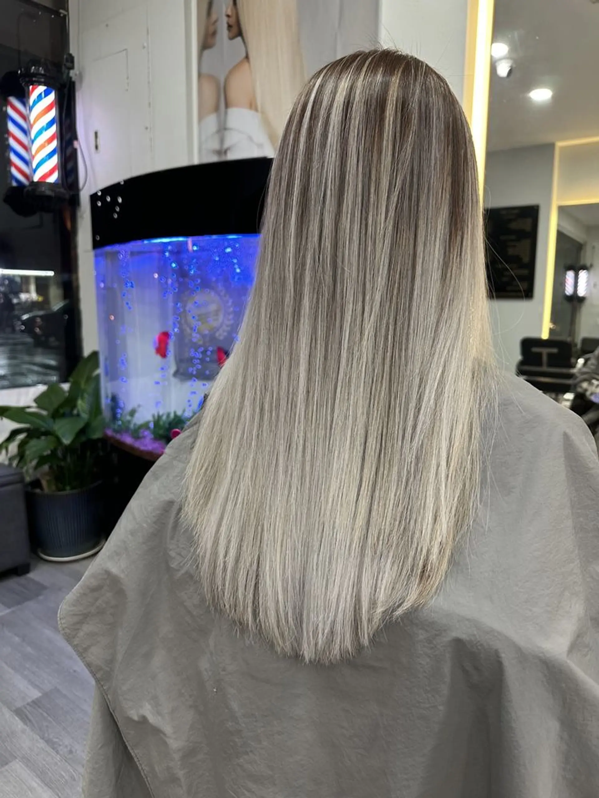 Long straight hair with a rooted icy blonde balayage. 1