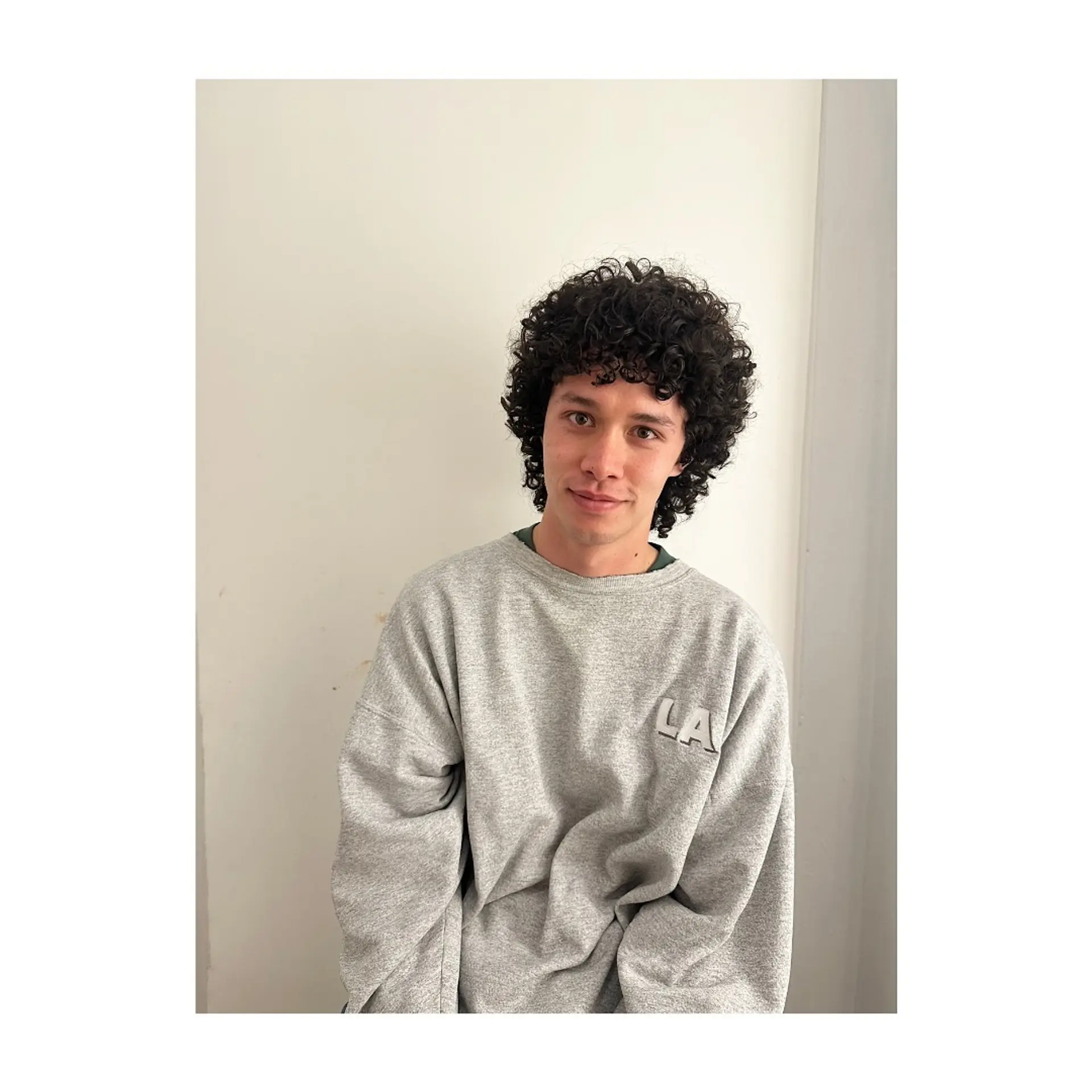 A rounded, layered curly cut featuring tight, defined curls and a full curly fringe framing the face. 1