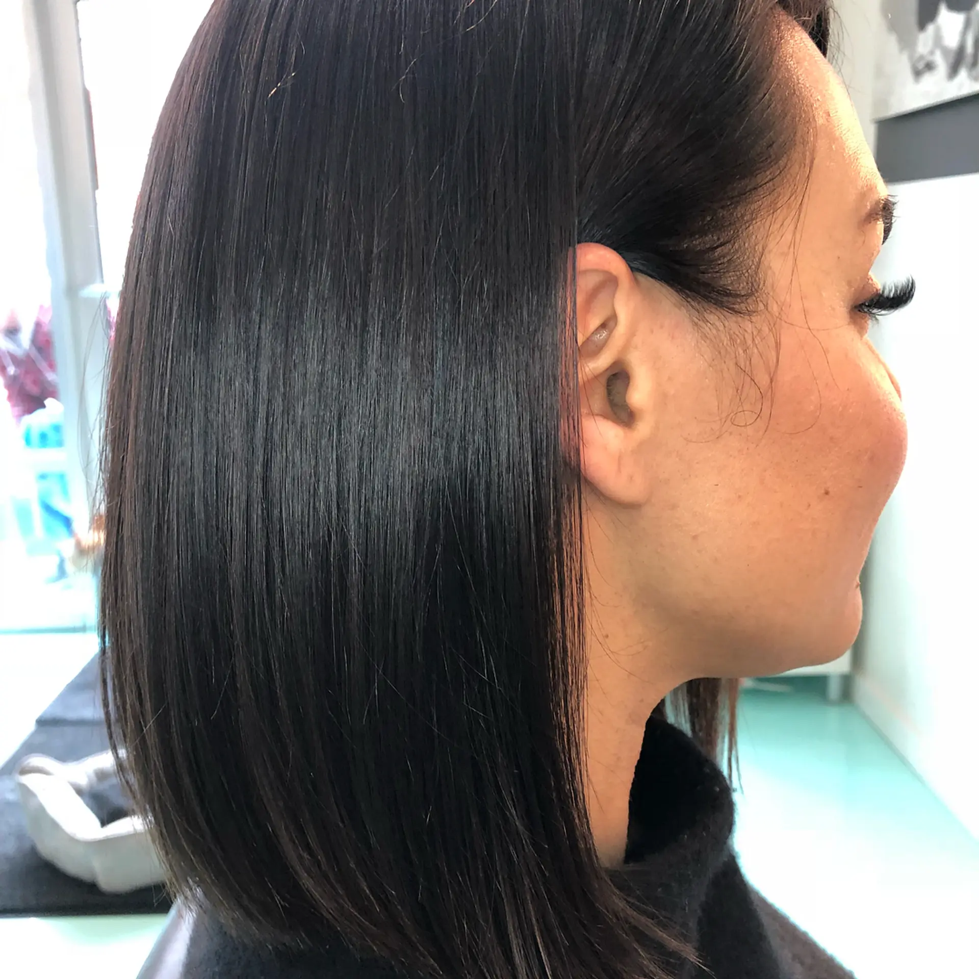 A sleek, straight lob cut in a deep, glossy chocolate brown finish. 1