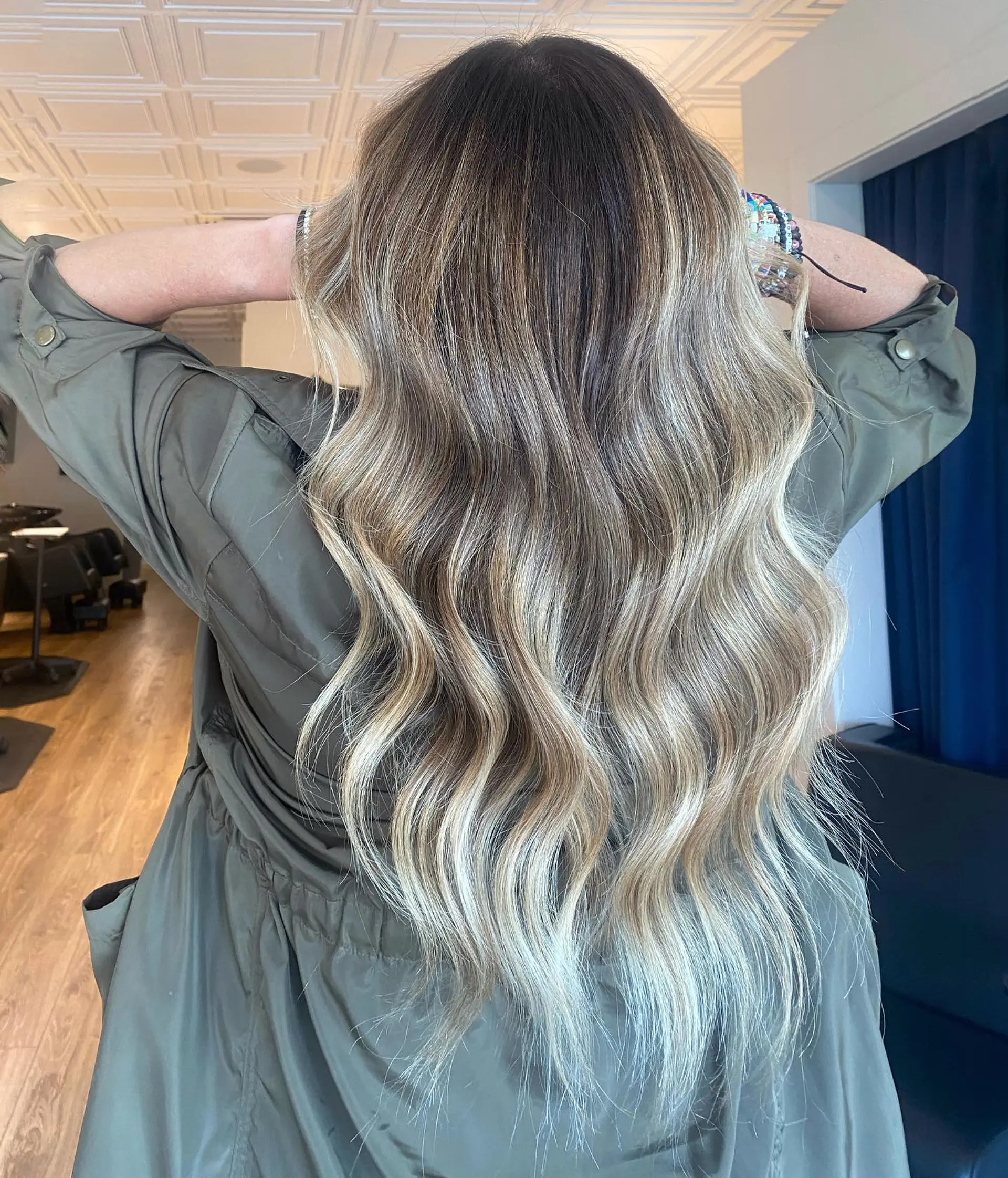 Long hair featuring a seamless blonde balayage with a shadowed root, styled into soft, flowing loose waves. 1