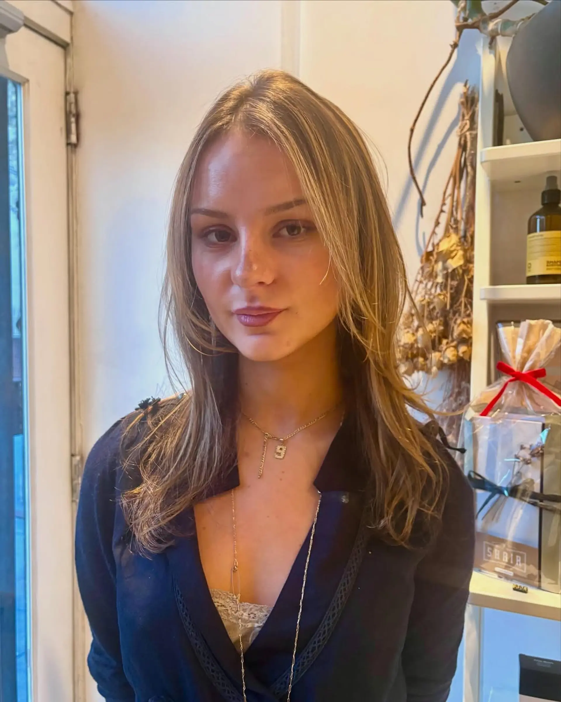 A medium-length layered hairstyle with blonde balayage. 1