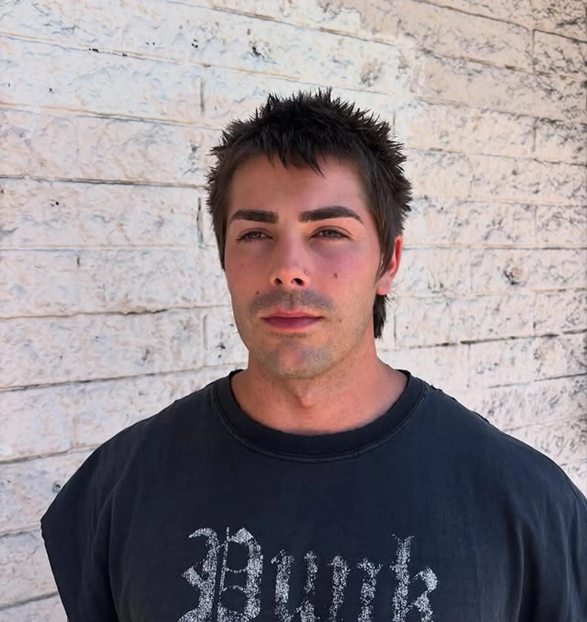 A short, textured crop top haircut with a spiky finish. 1