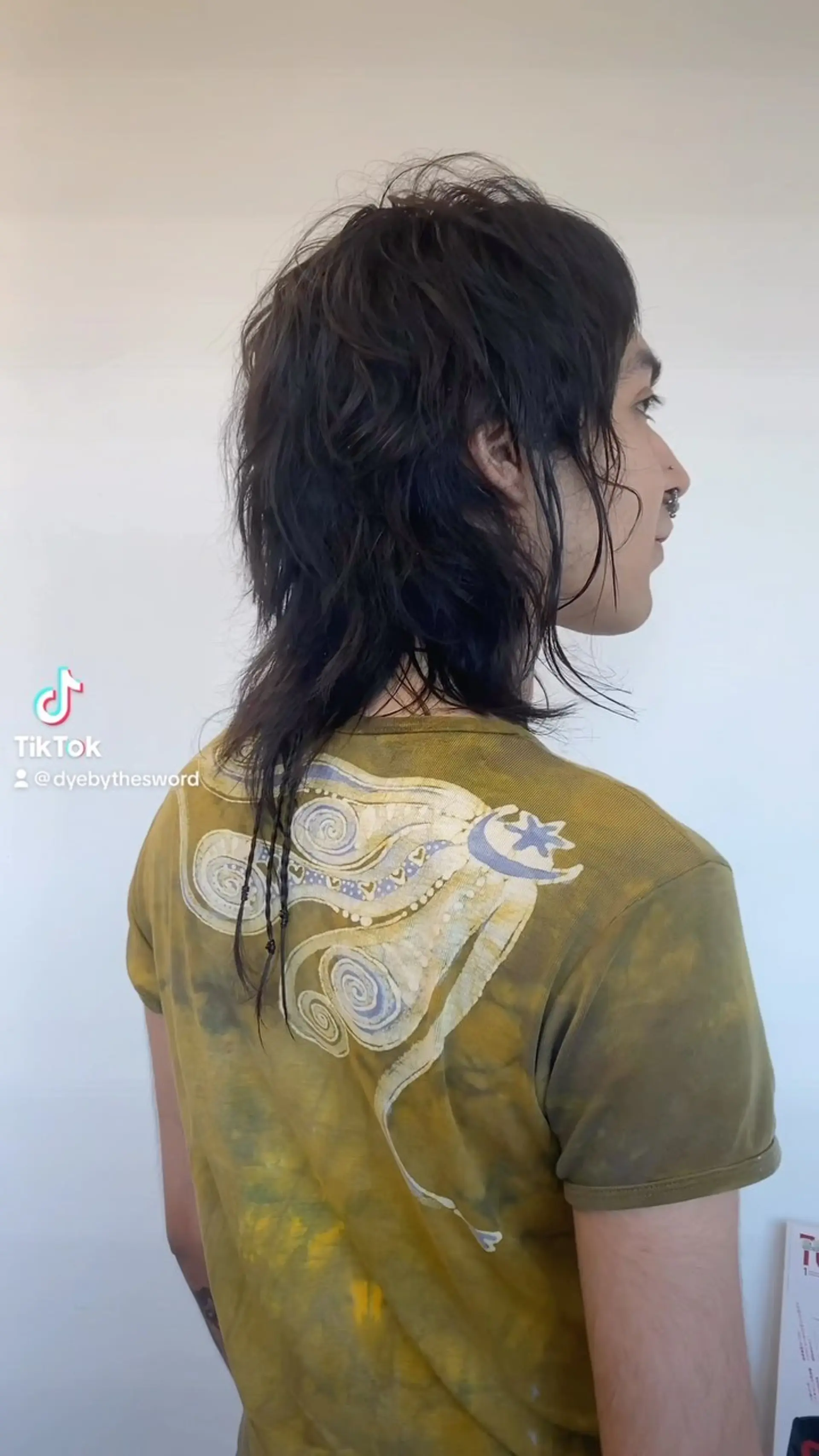 A soft, textured shaggy mullet featuring choppy layers, face-framing pieces, and a subtle accent braid extending at the nape. 1