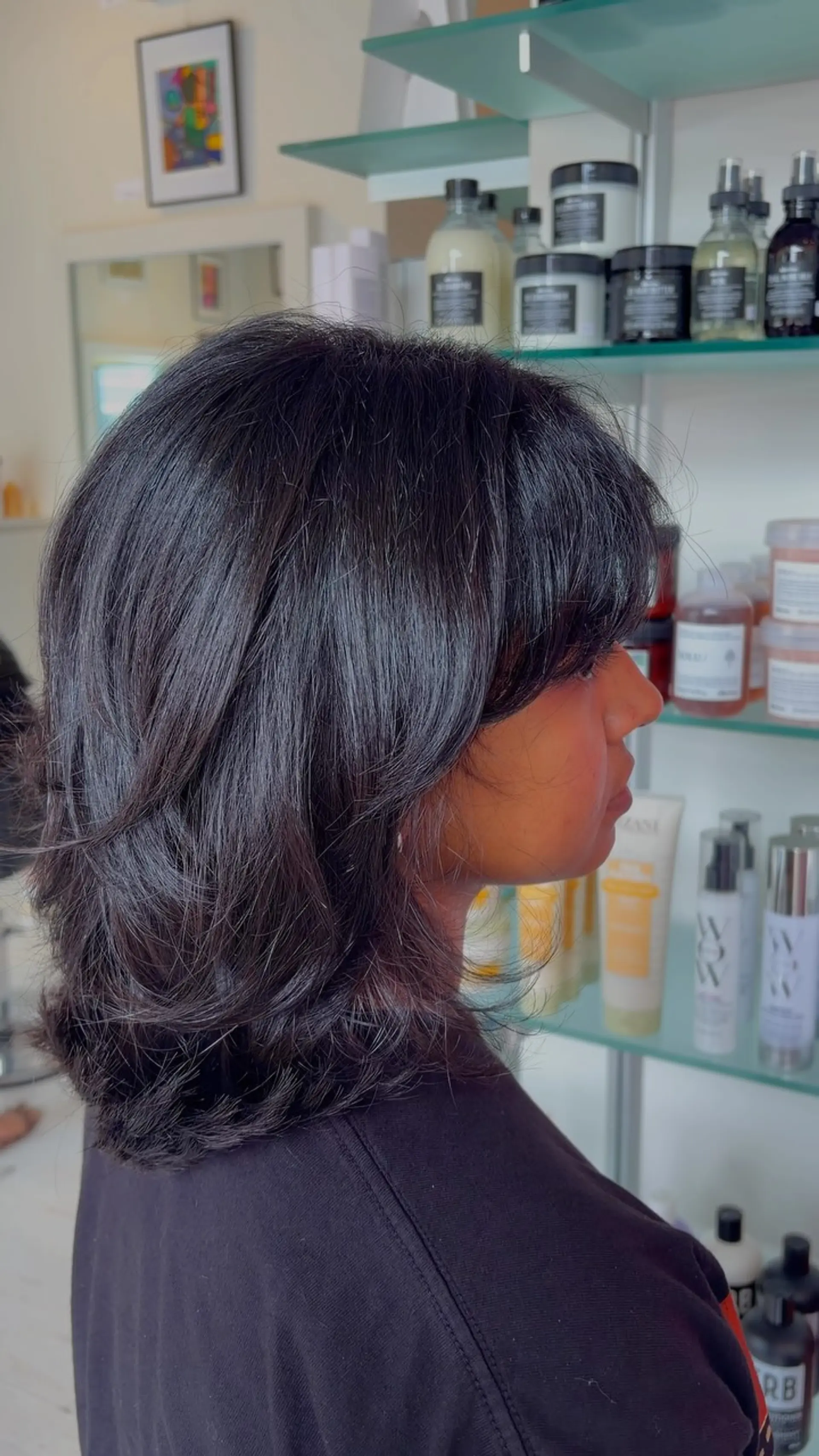 A textured medium-length shag haircut featuring soft layers and face-framing bangs. 1