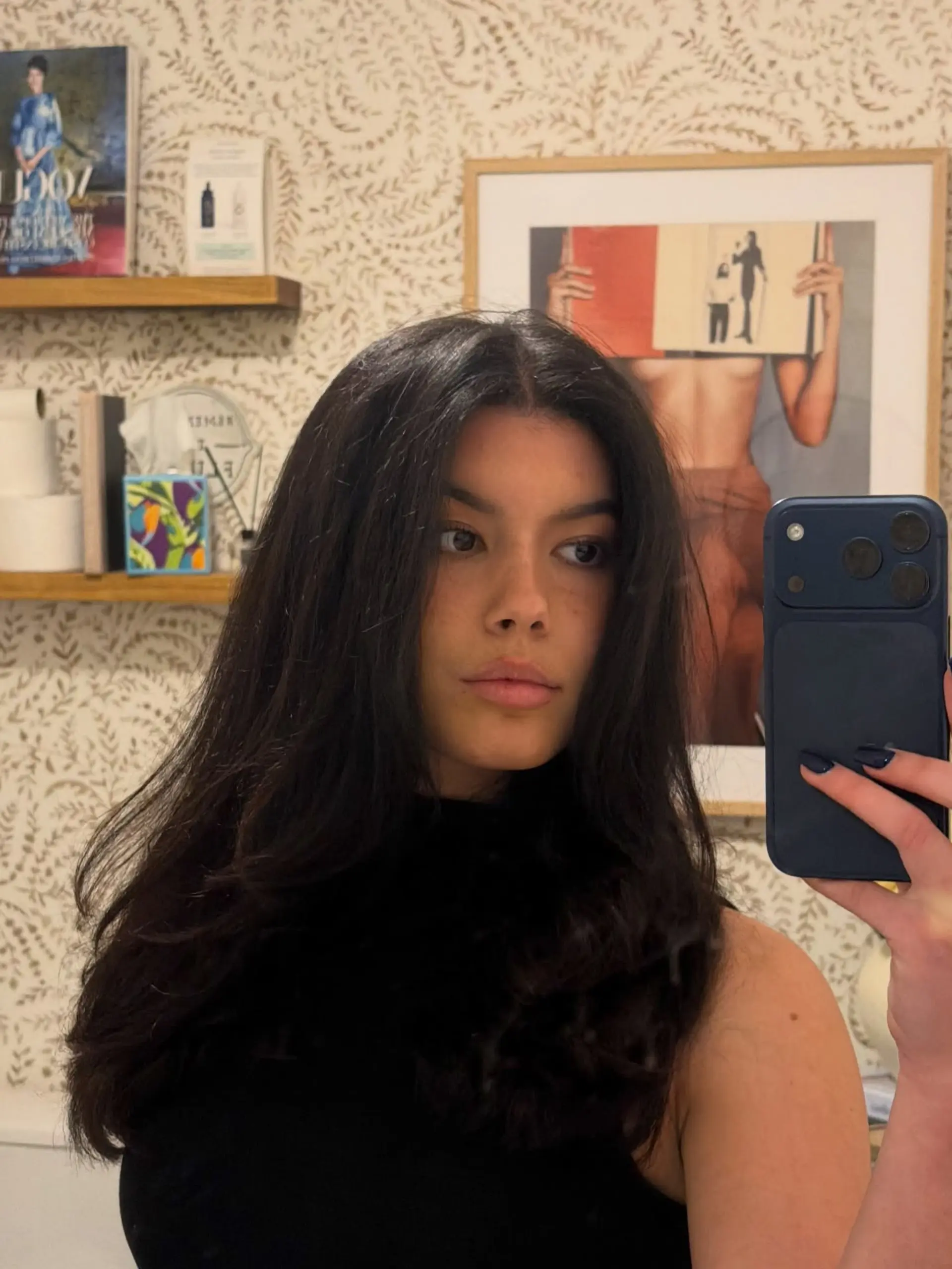 A long, voluminous dark brunette blowout with a center part and soft, rounded bounce through the ends. 1
