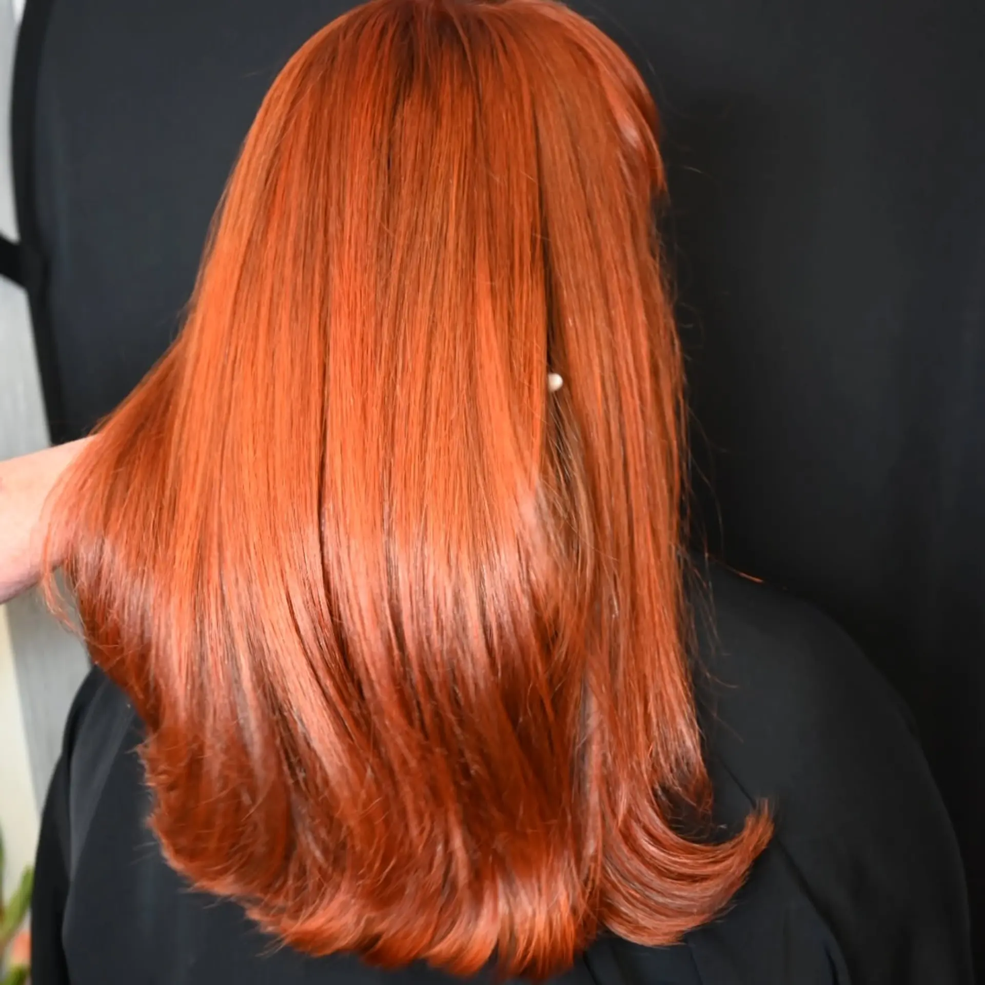 Vibrant copper red long hair with a smooth, straight finish and soft flipped ends. 1