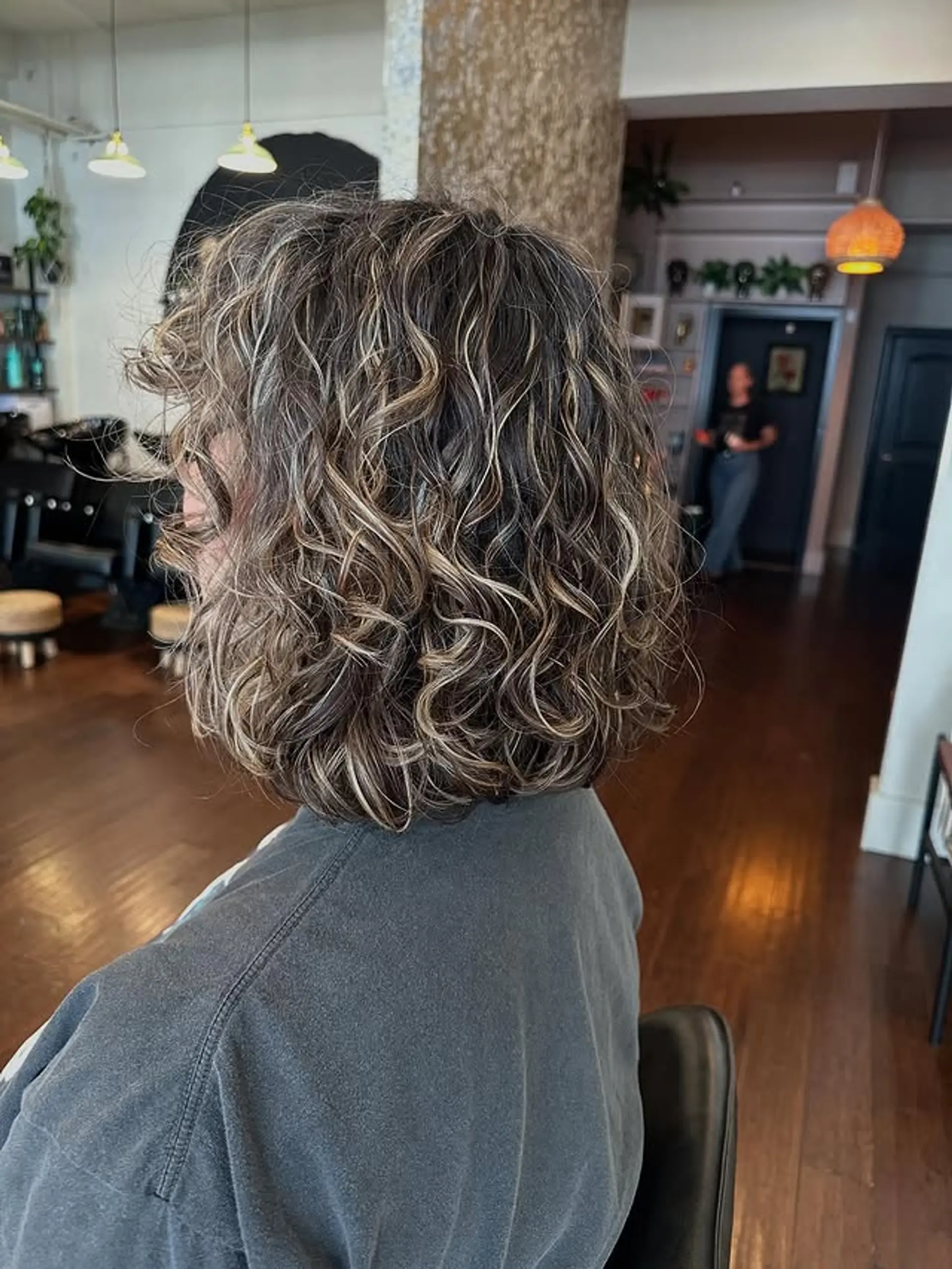 A textured, curly bob with strategically placed highlights to enhance movement and dimension. 1