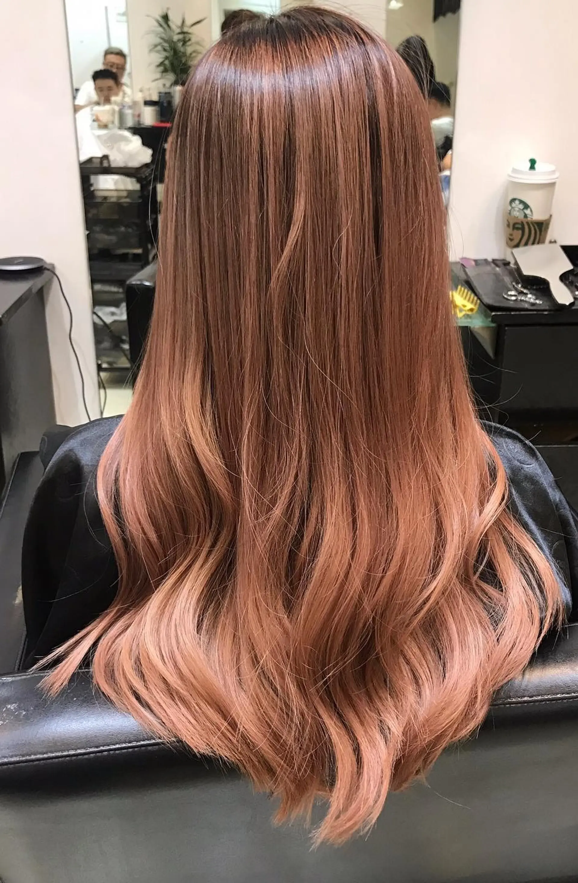 A long, straight hairstyle with rose gold ombre and soft waves. 1