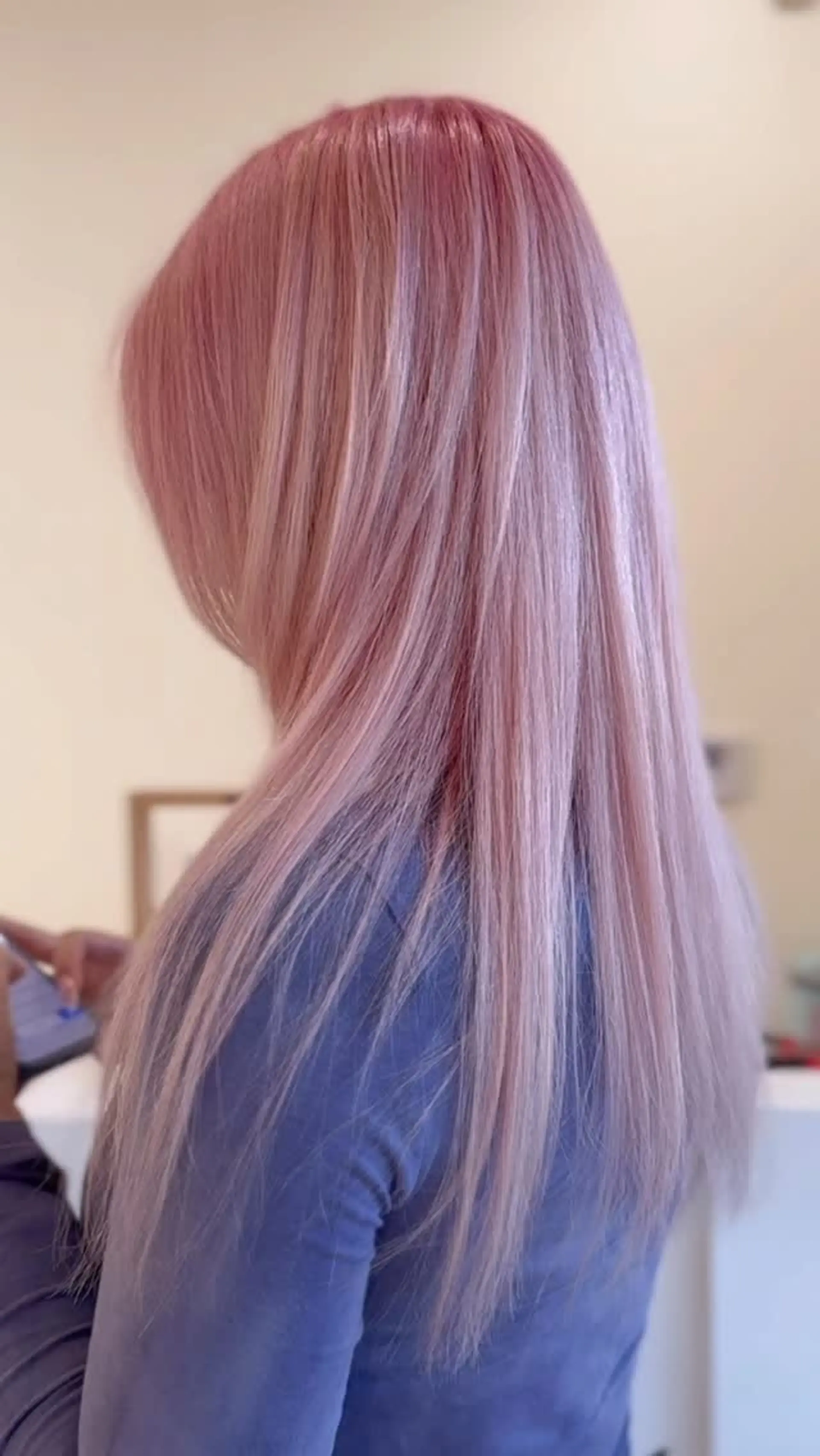 Long straight hair styled sleek in a soft pastel pink shade. 1