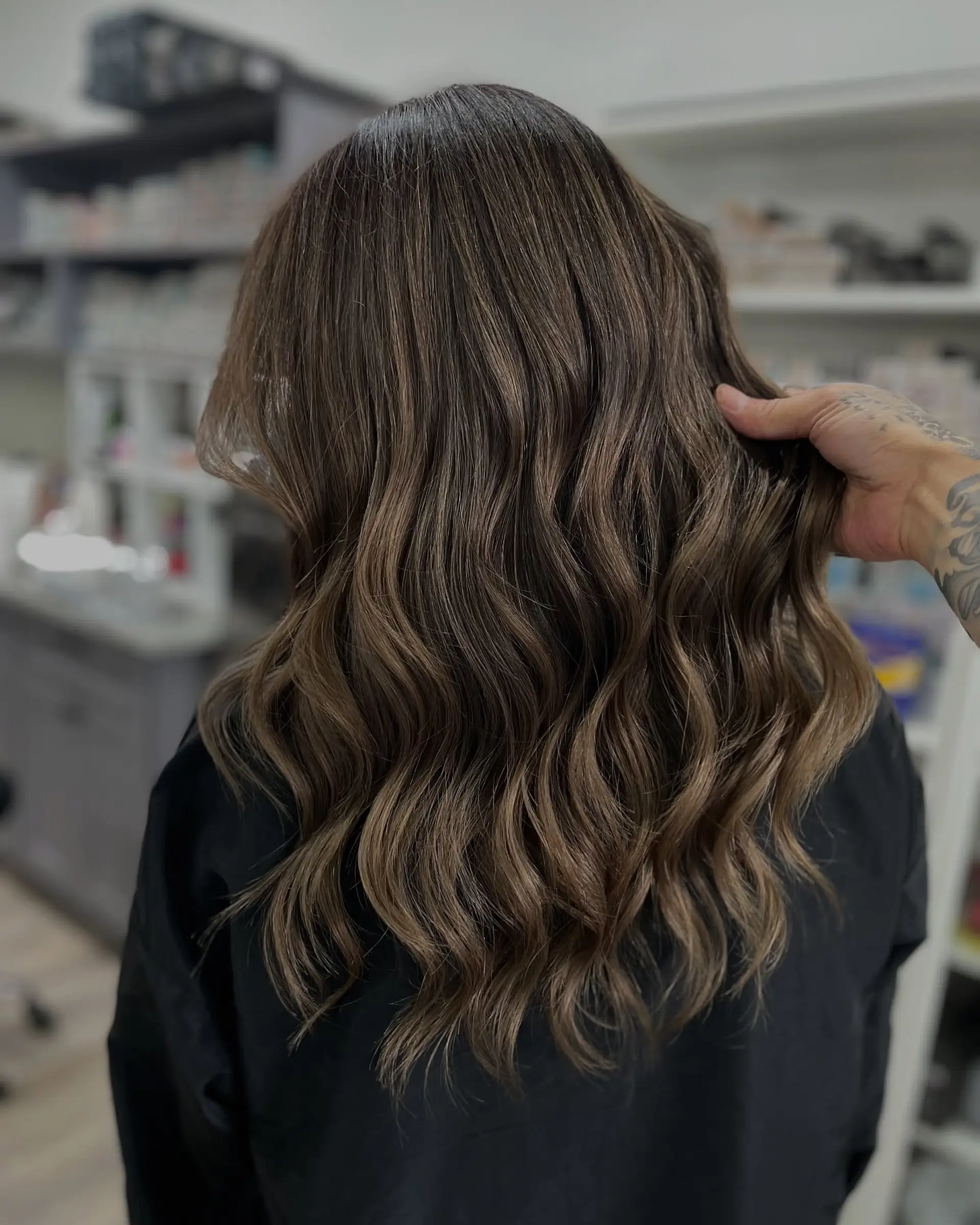 Long, soft waves with caramel highlights that add dimension and movement. 1