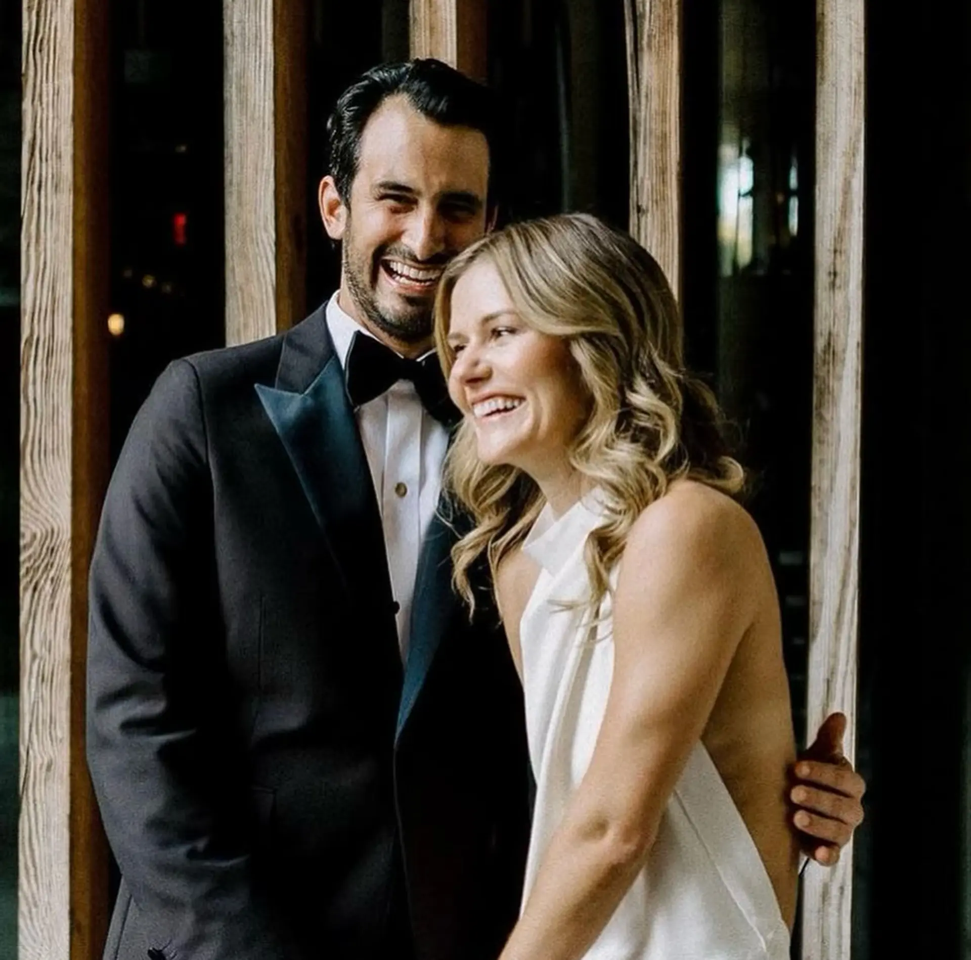 Soft, natural bridal waves styled down with a center part for an effortless wedding look. 1