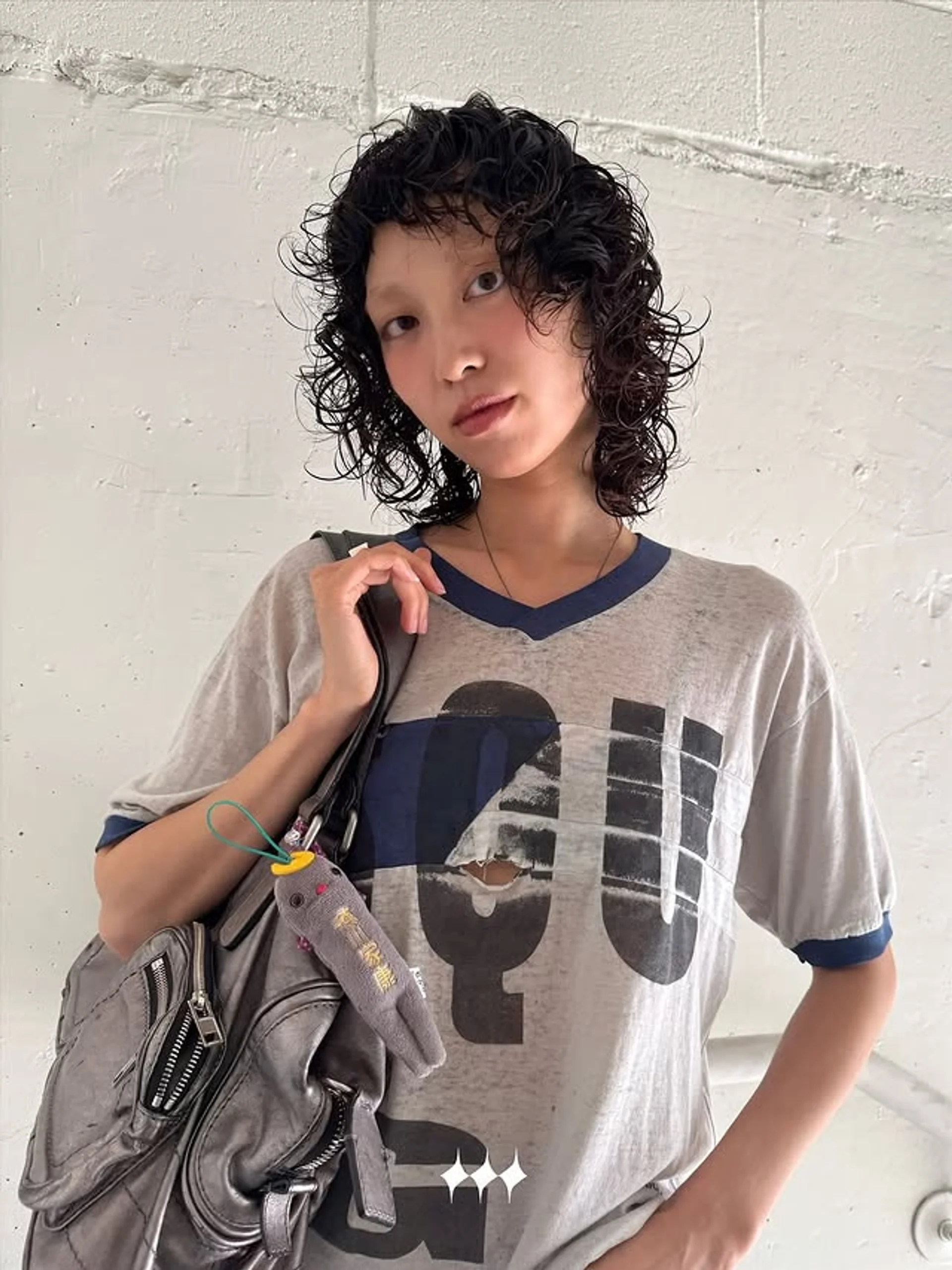 A woman with a classic short curly bob, styled with natural, defined voluminous curls. - Preview 2